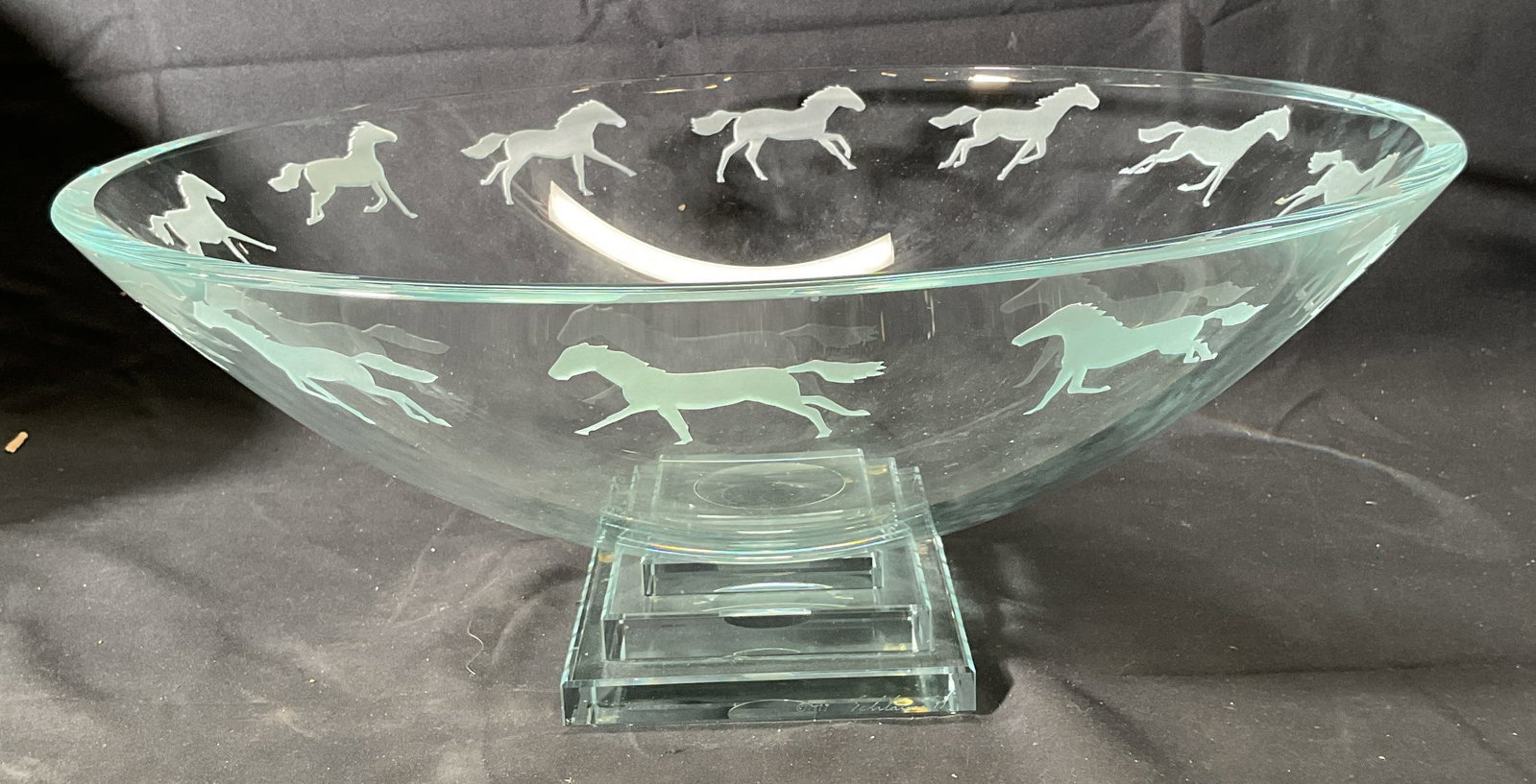 Stephen SCHLANSER Equus Bowl 1997, 16 Inches: Stephen SCHLANSER Equus art glass bowl. Wide mouth bowl with pedestal base. Galloping horse motif around rim. Signed on base. Thick walled glass, piece is heavy. Measures approx. 16 x 6.75 inches. Som