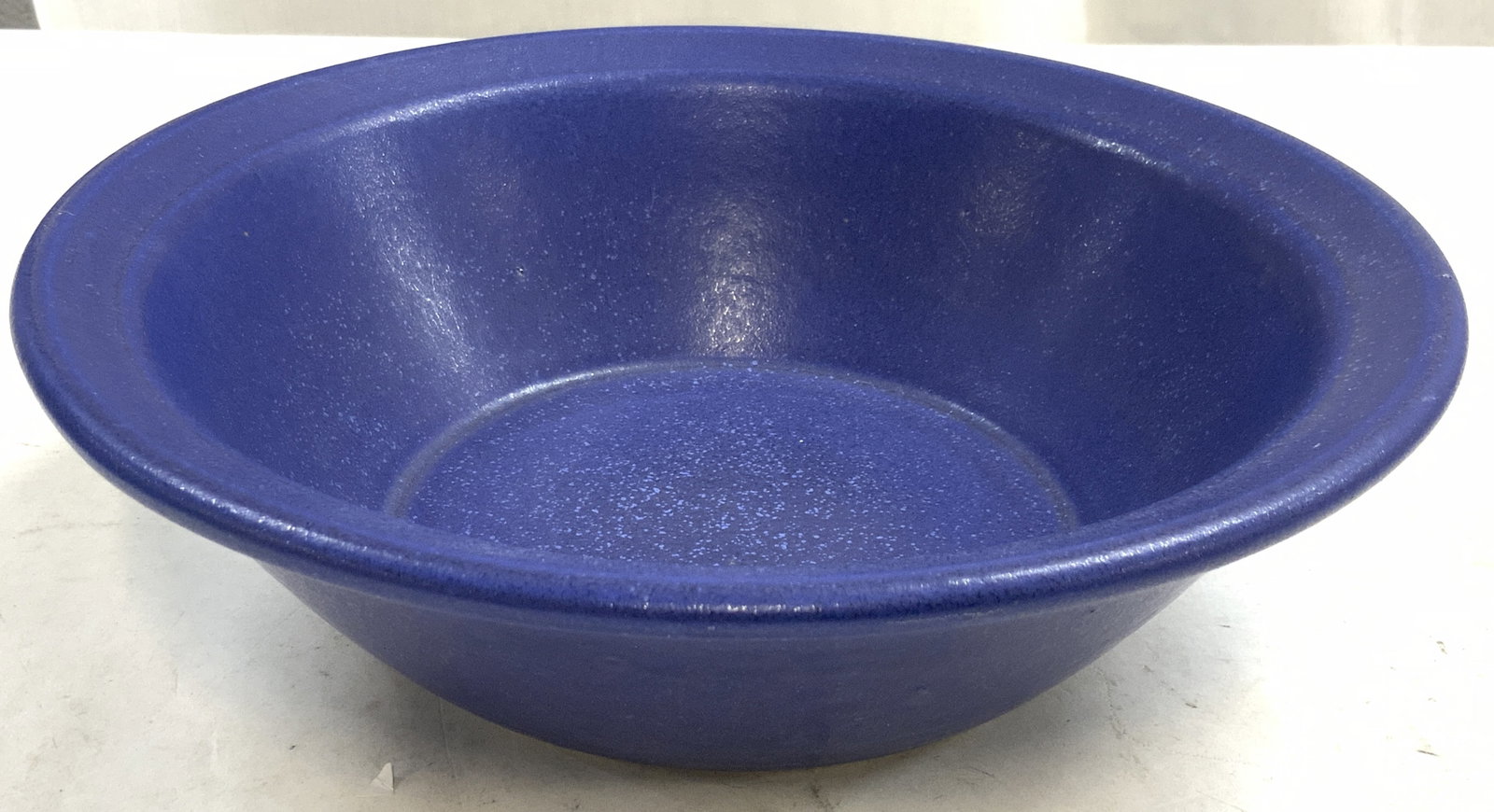 WEAVER MAINE KILN WORKS Ceramic Bowl Vessel: Underside is inscribed WEAVER MAINE KILN WORKS. Bowl is blue toned and ceramic. Piece has rim which leans outward. Underside is tan toned with unfinished texture. Vessel measures approximately 9.25 in