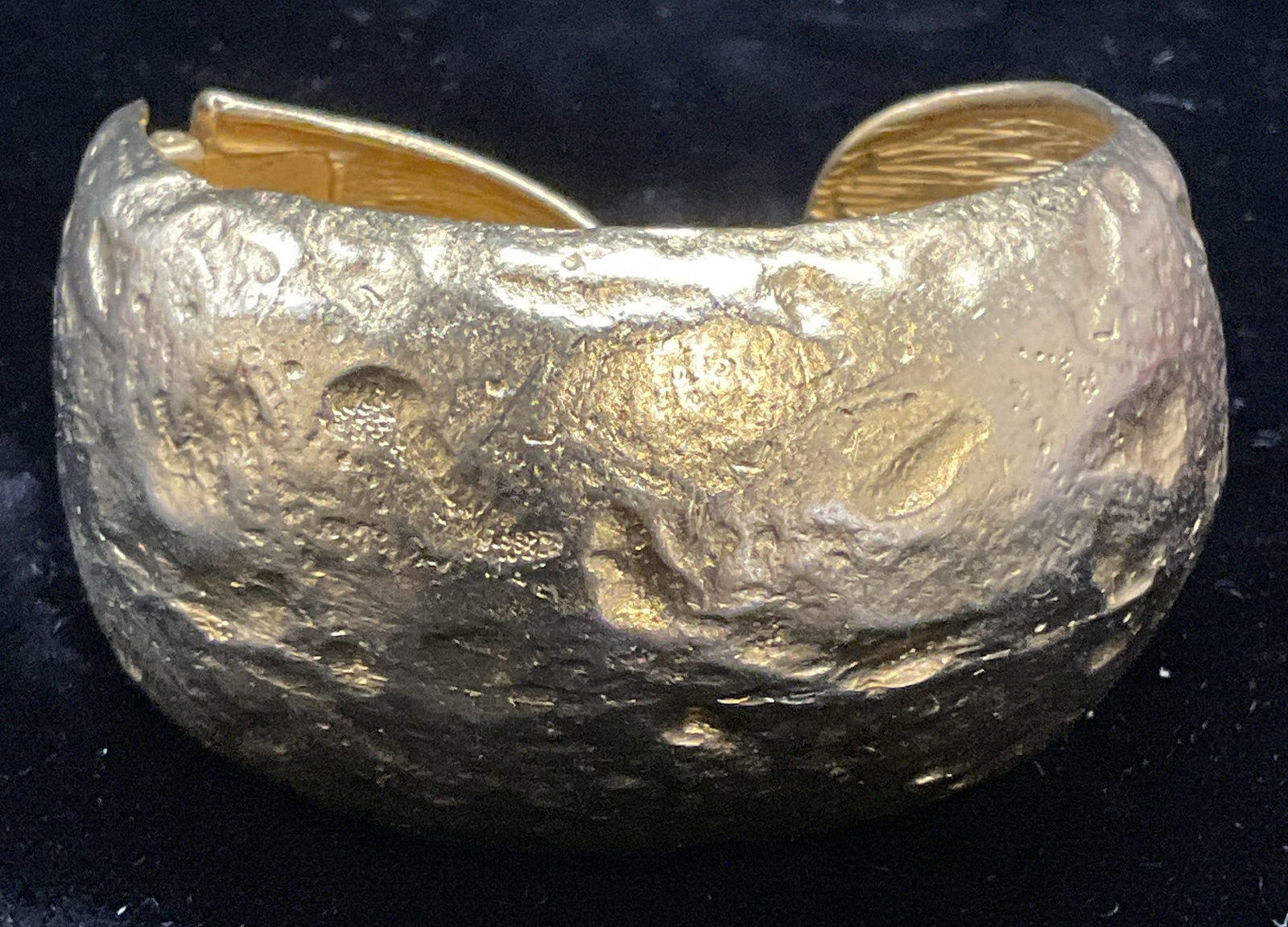 Vtg Kenneth Lane Gold Tone Textured Bracelet: Vintage Kenneth Lane gold tone textured band cuff bracelet. Singed on interior. Made in USA. Measures approx. 2 1/8 inches wide. Band approx 1 3/8 inches wide. Some surface wear including scratching o