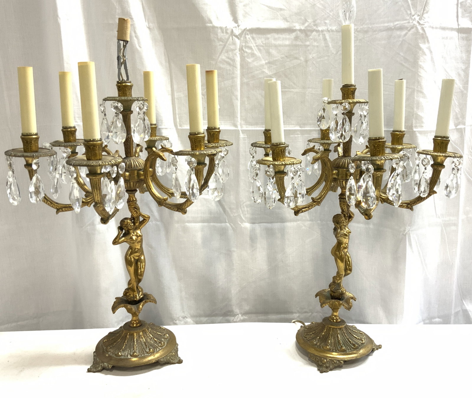 Pr 7 Arm Brass Fem Nude Victorian Sconces W Shades: Lot includes 2 sconces. Each are vintage. Sconces are gold toned and brass. Each piece has female nude figures to stems. Sconces each have 6 C scroll arms & 1 center arm. Each piece has 3 scroll detai