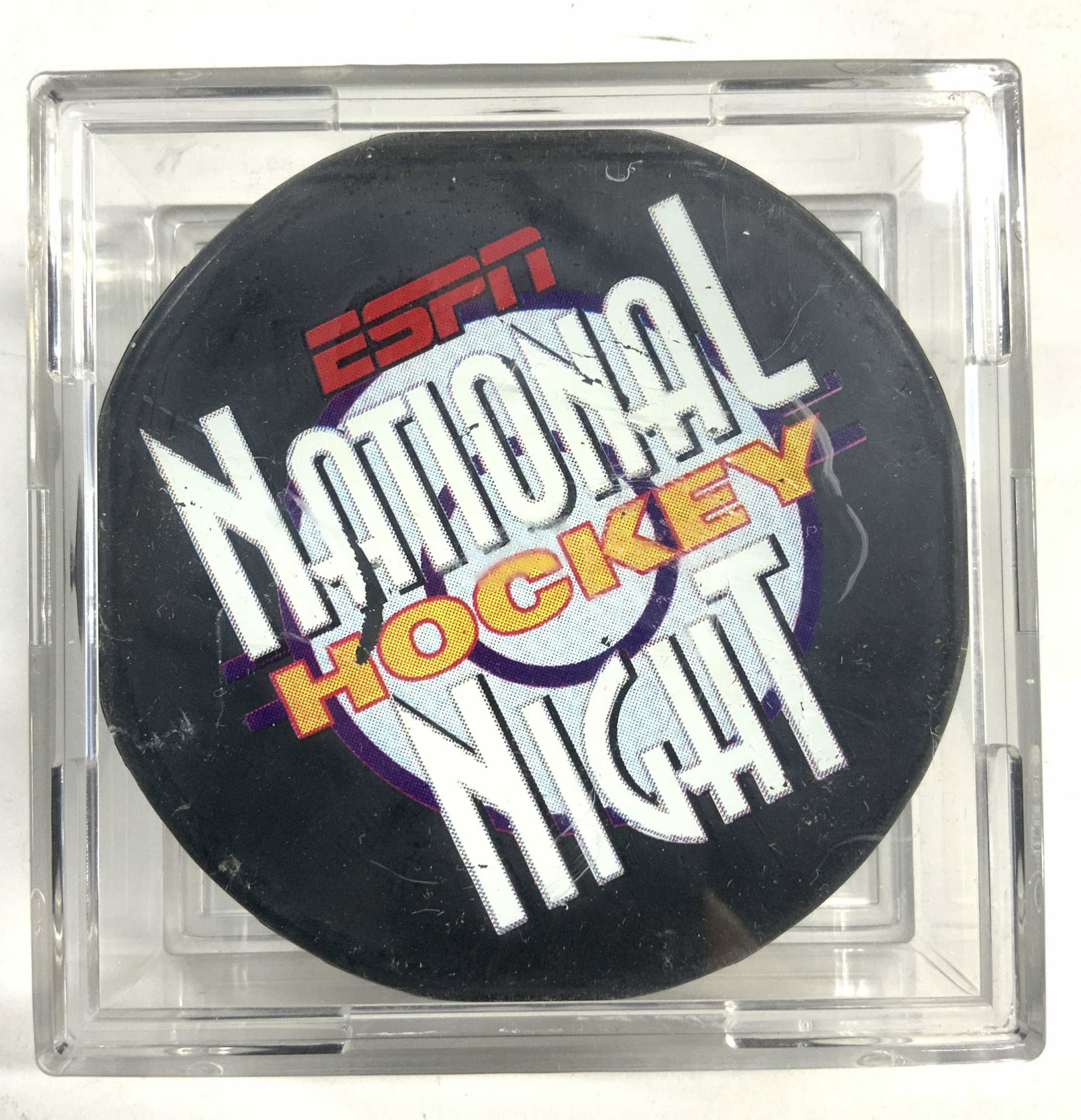 ESPN NATL HOCKEY NIGHT Hockey Puck In Case: Puck reads ESPN NATIONAL HOCKEY NIGHT, other side reads ESPN. Sides read FOTOPUCK. Puck has lettering with multiple tones. Acrylic case measures approximately 3 inches square 1.25 inches tall. Puck, h