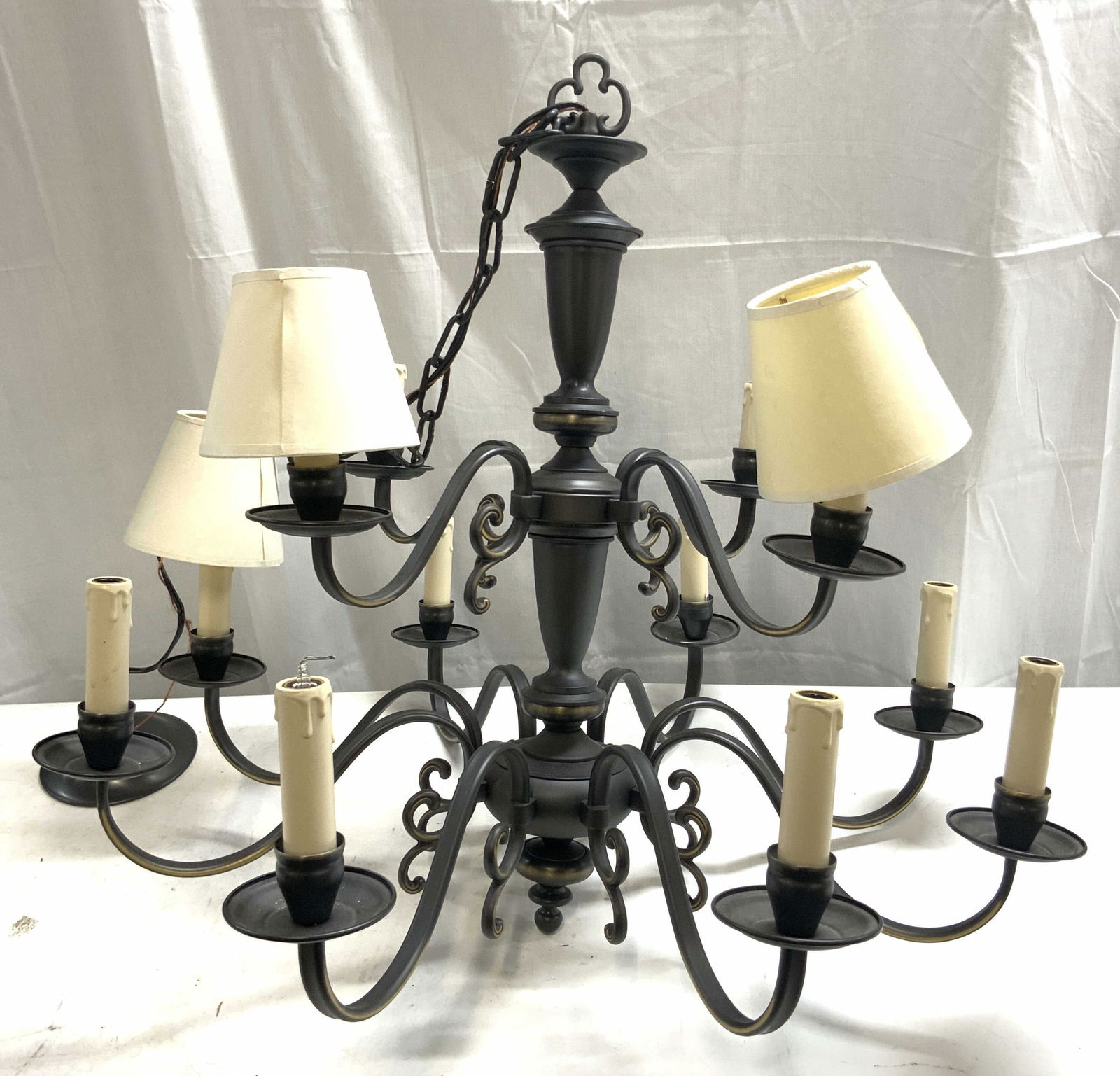 12 Arm Two Tier Metal Chandelier: Chandelier is metal. Piece has 12 arms. Each arm has S curve structures. Each bulb socket has candlestick forms. Chandelier includes 3 shades. Each chandelier measures approx 26 inches tall ( without