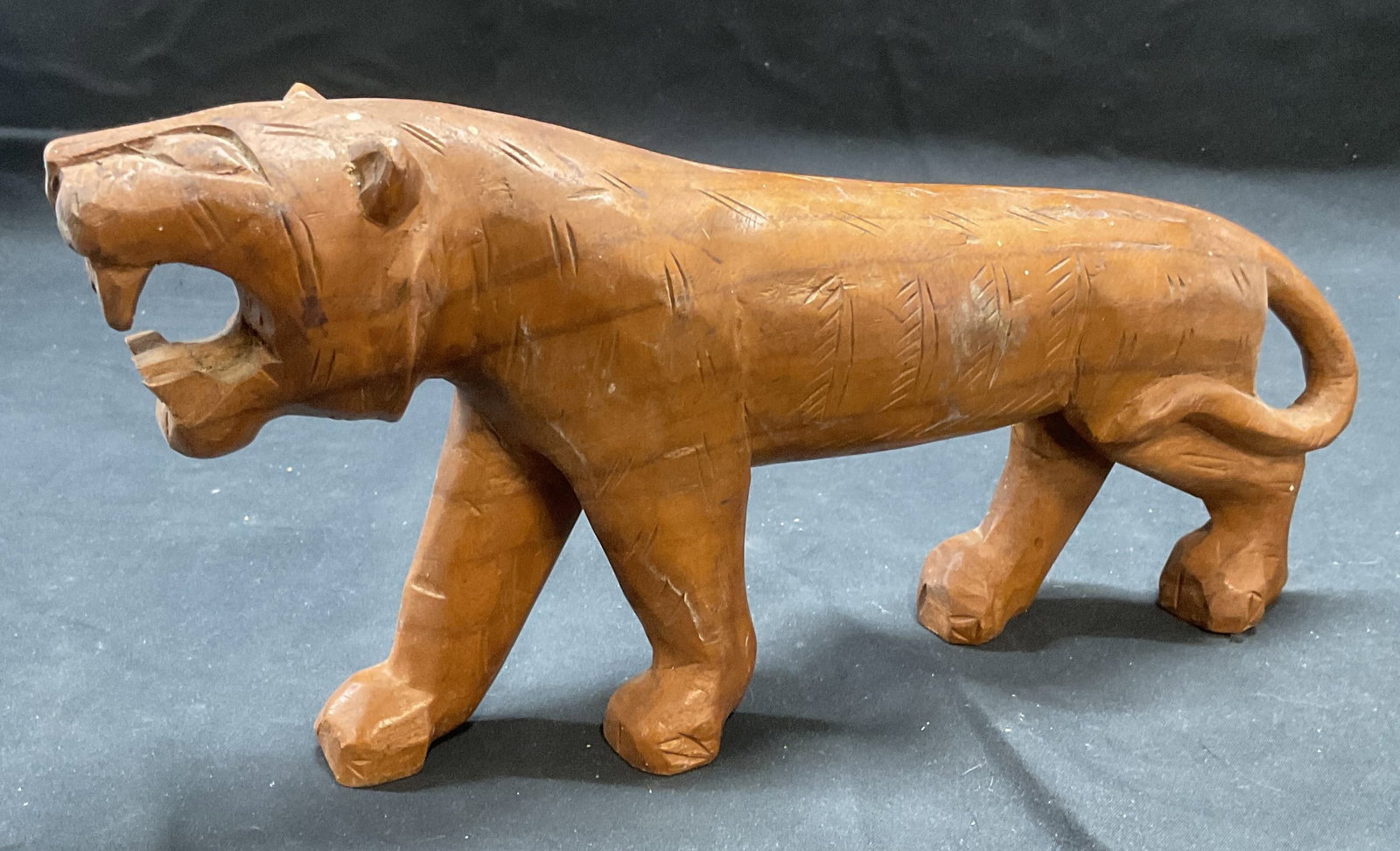 Vintage Carved Wood Big Cat Figural: Vintage carved wood big cat figural. Measures approx. 11 x 2.5 x 5.75 inches. Some surface wear including scratching observed. Big cat, big cat figural, wood carving, decorative arts, home decor, home