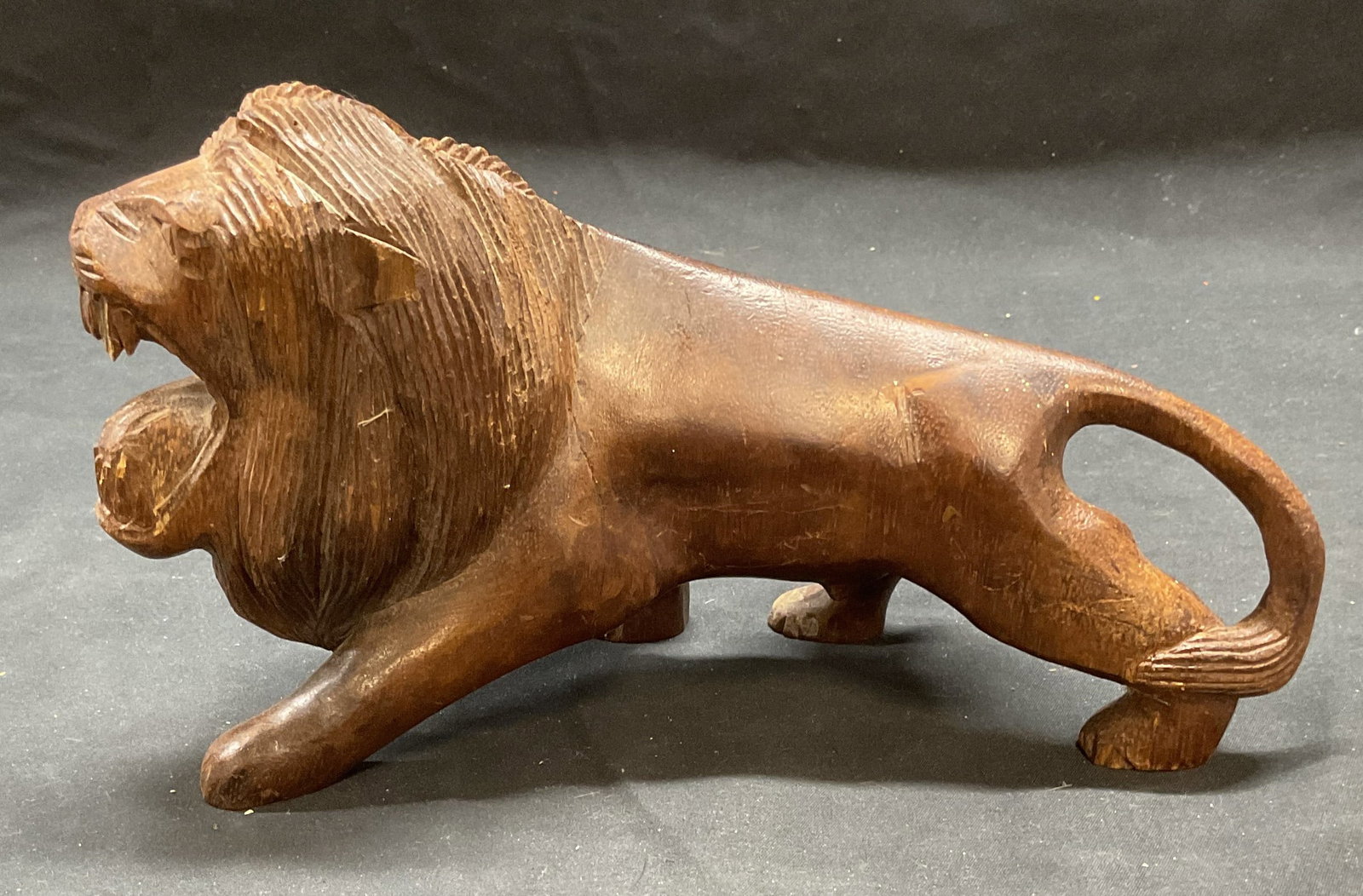 Vintage Carved Wood Lion Figural: Vintage carved wood lion figural. Measures approx. 9.25 x 3.25 5.5 inches. Some surface wear including scratching and small chips observed. Lion, wood lion, lion figural, decorative arts, home decor, 