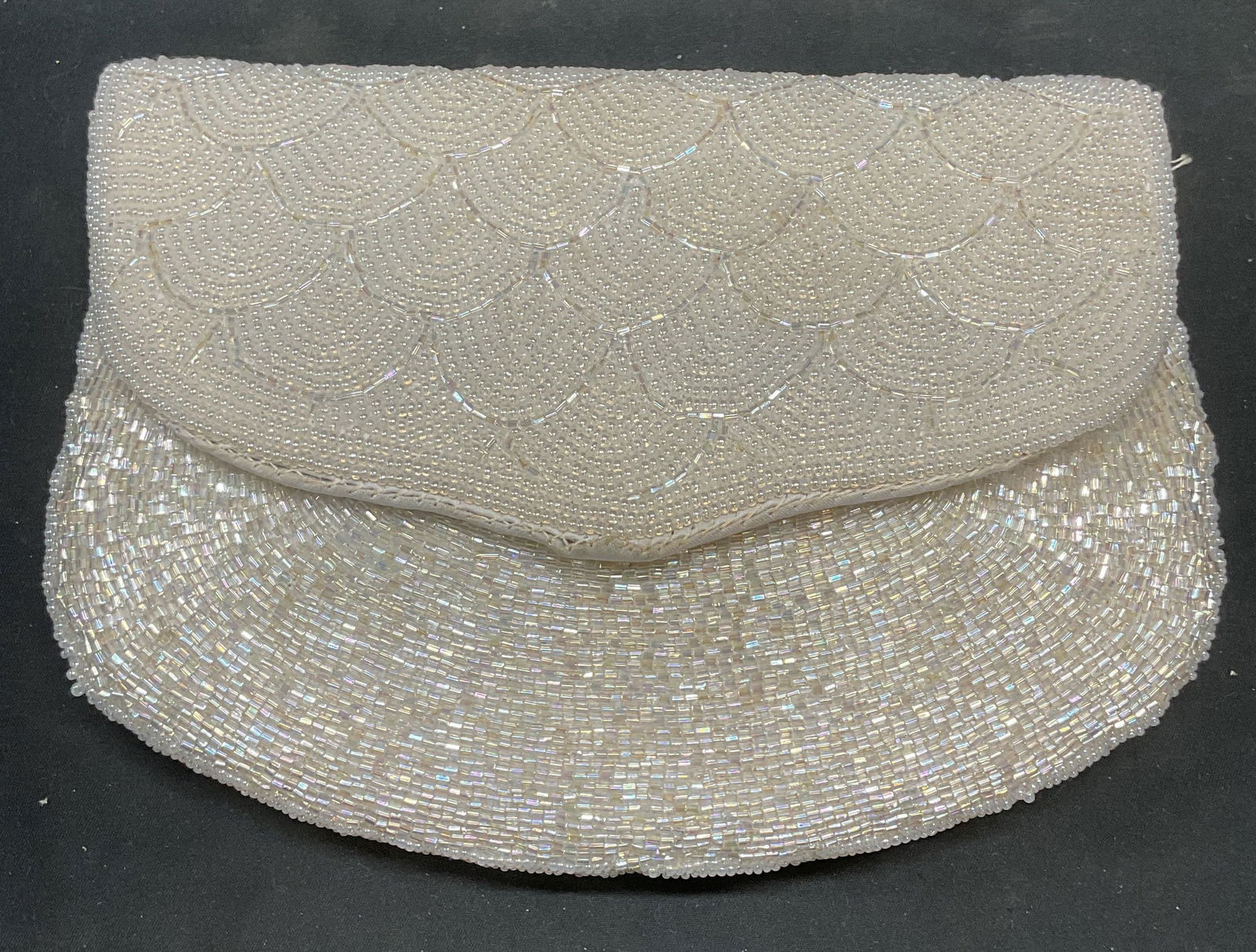 Vintage ADG White Beaded Clutch Handbag: Vintage ADG white beaded clutch/handbag. Shoulder strap and interior slip pocket. Signed on interior. Measures approx. 8 x 6 inches. Some blemishes observed. Shoulder strap needs repair. ADG clutch, A