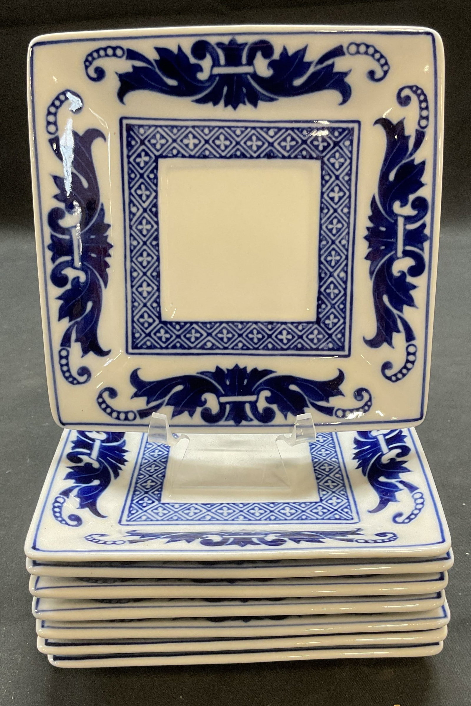 Set 8 Bombay Porcelain Hors Doeuvres Plates: Set of 8 Bombay porcelain hors Doeuvres plates. Blue and white with scroll design. Signed on undersides. Measure approx. 5 x 5 inches each. All pieces have surface wear consistent with exposure. Bomba