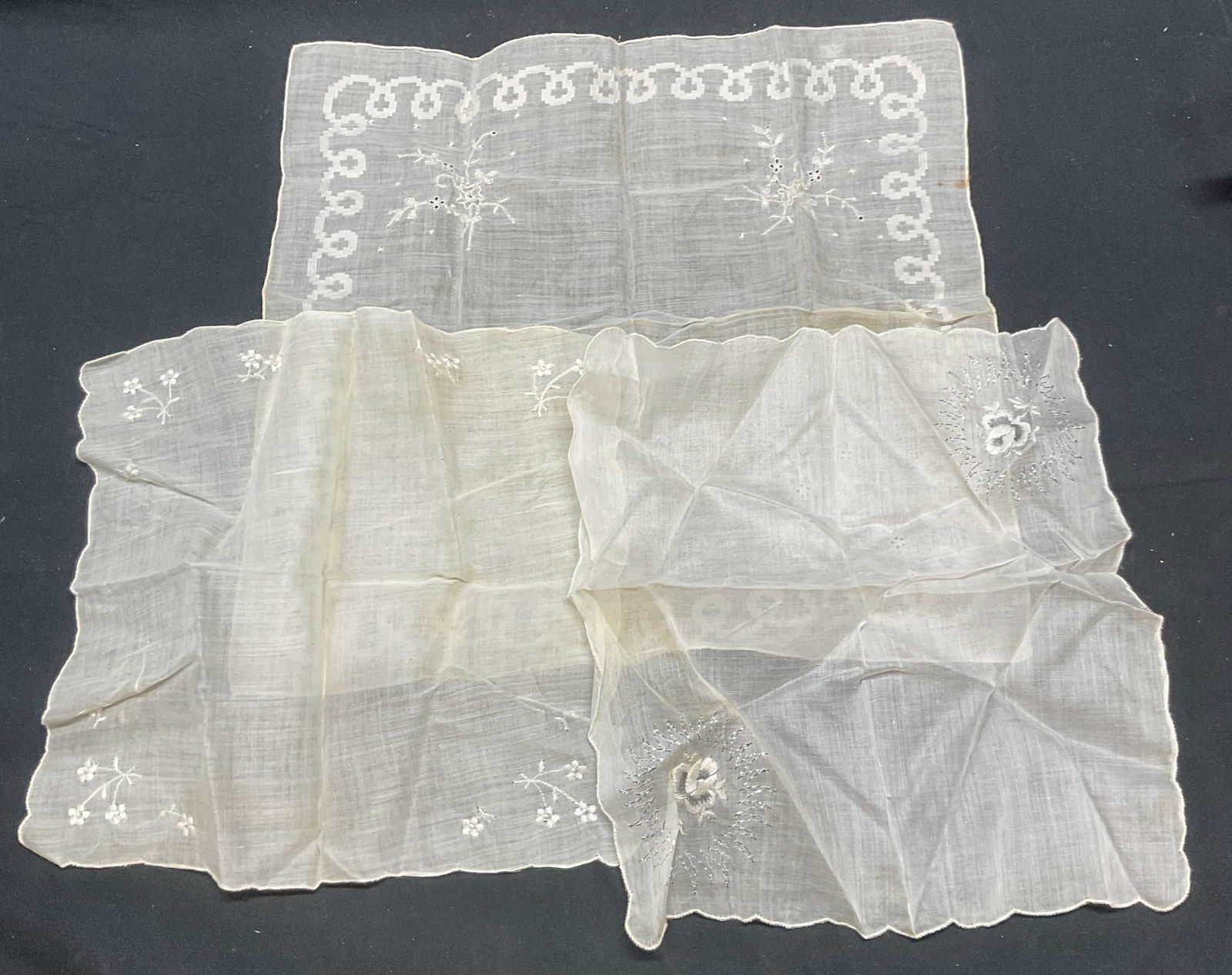 Lot 3 Vtg White Embroidered Floral Handkerchiefs: Lot of 3 vintage handkerchiefs with embroidered designs. White, material feels like cotton. Sizes vary. Largest approx. 12 x 11.5 inches. Both pieces have some wear to material consistent with exposur