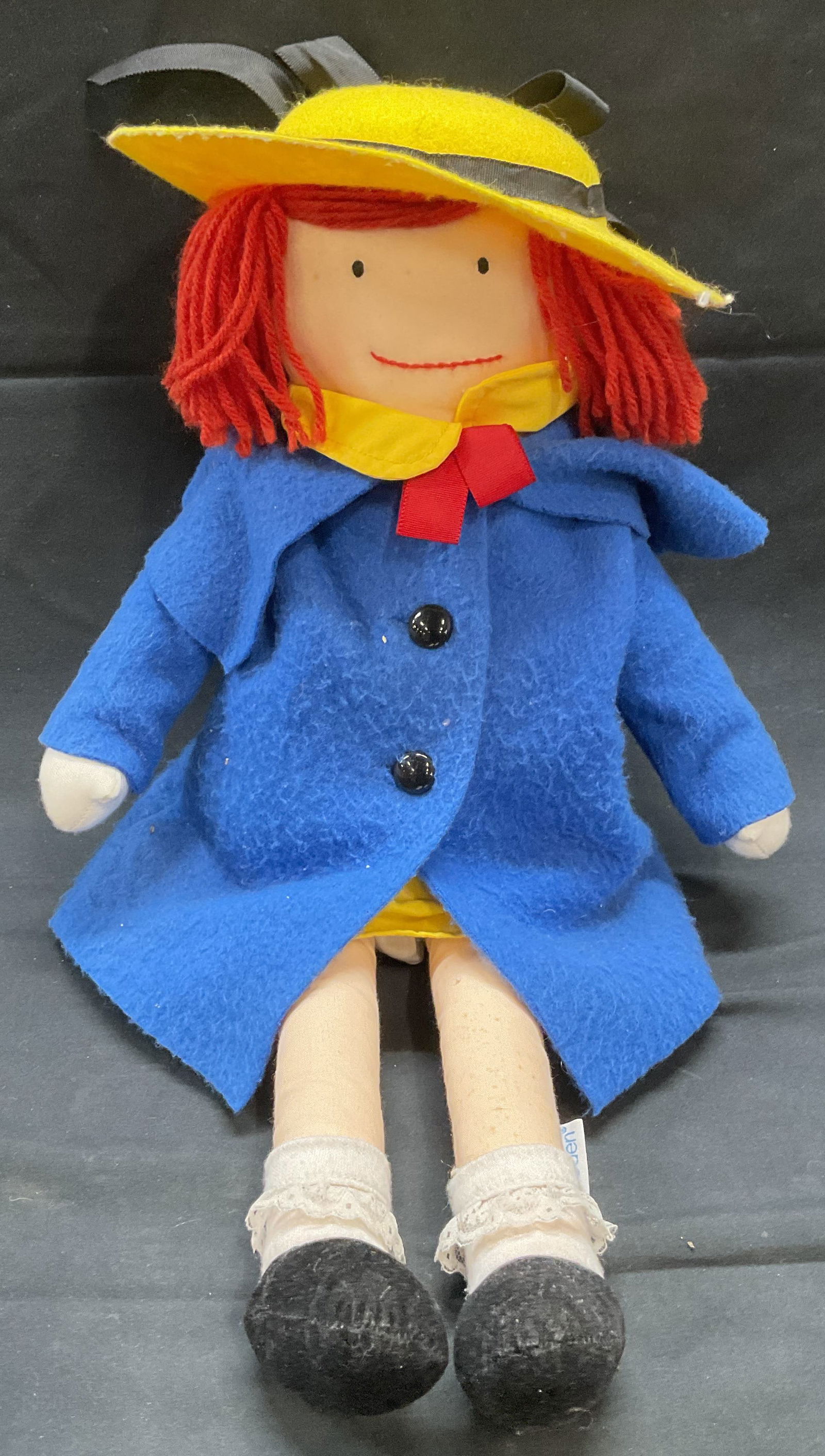 Vintage 1990 Eden Madeline Doll: Vintage 1990 Eden Madeline doll. Fabric. Blue coat and yellow hat. Measures approx. 18 inches long. Some wear including pilling and blemishes observed. Madeline doll, Madeline, vintage doll, vintage t