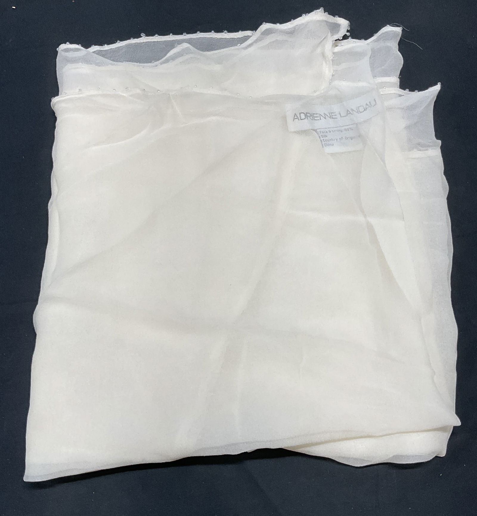 Adrienne Landau White Silk Beaded Scarf: Adrienne Landau white silk scarf with beaded trim. Measures approx. 78 inches long. Some pulling, small holes, and losses observed. Adrienne landau, Adrienne landau scarf, designer scarf, designer acc