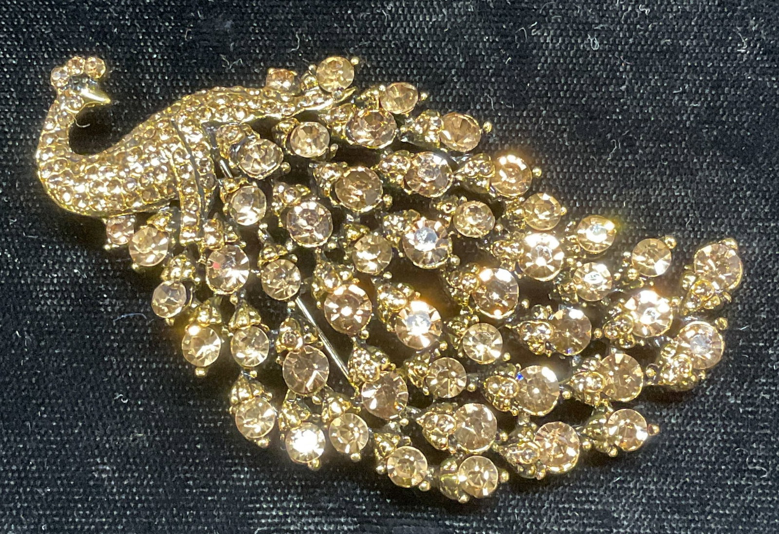 Gold Tone Crystal Peacock Brooch, 3 inches: Gold tone peacock motif brooch/pendant with crystal decoration. Hinge pin and bail on underside. Measures approx. 1.5 x 3 inches. Some surface wear including scratching observed. Jewelry, estate jewel