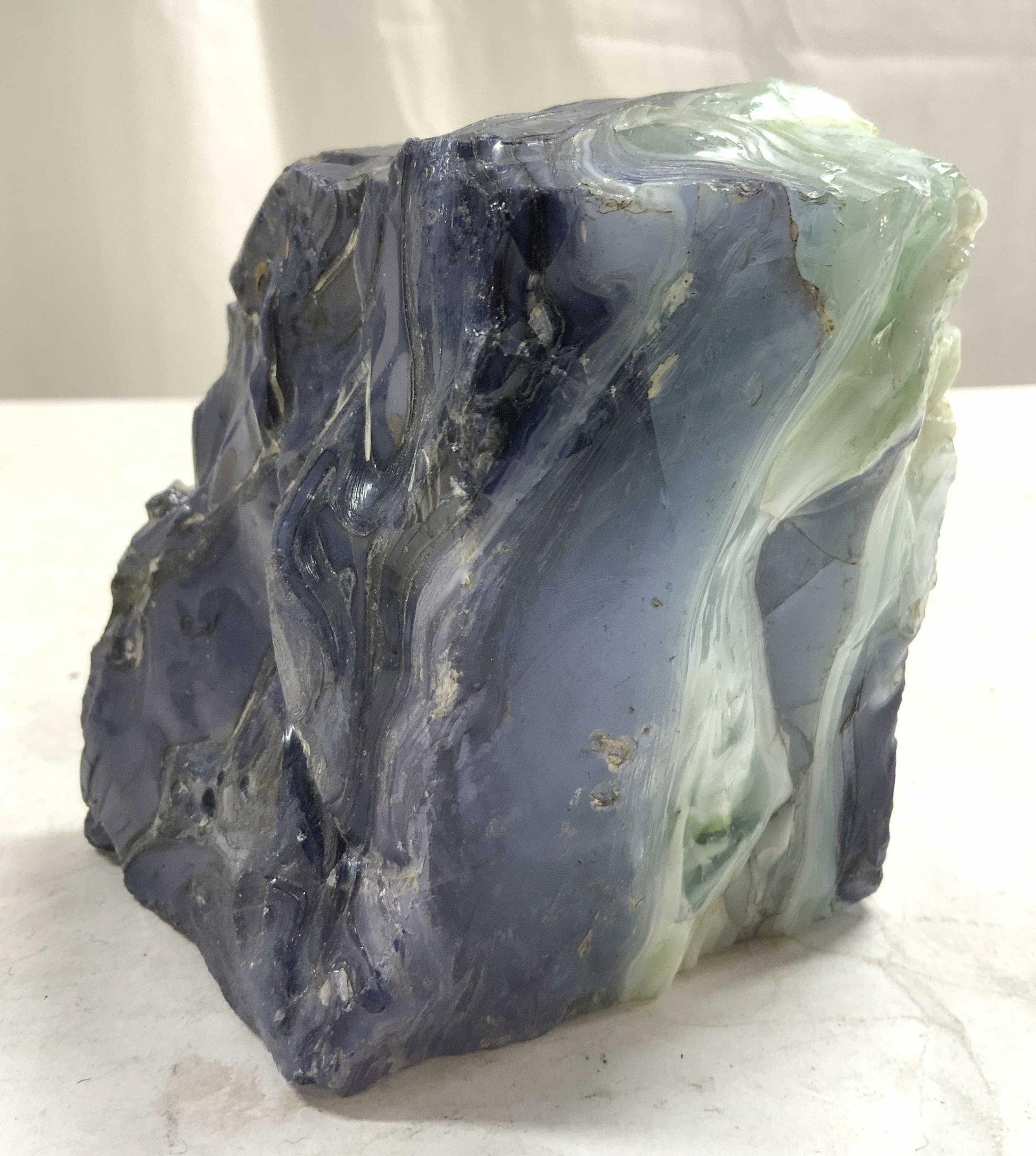 Vintage Slab W Banding Detail: Slab is vintage. Piece appears to be a heavyweight resinous material possibly glass. Piece has navy, ice blue, white & black toned. Slab has appearance of stone. Piece measures approximately 4 inches 