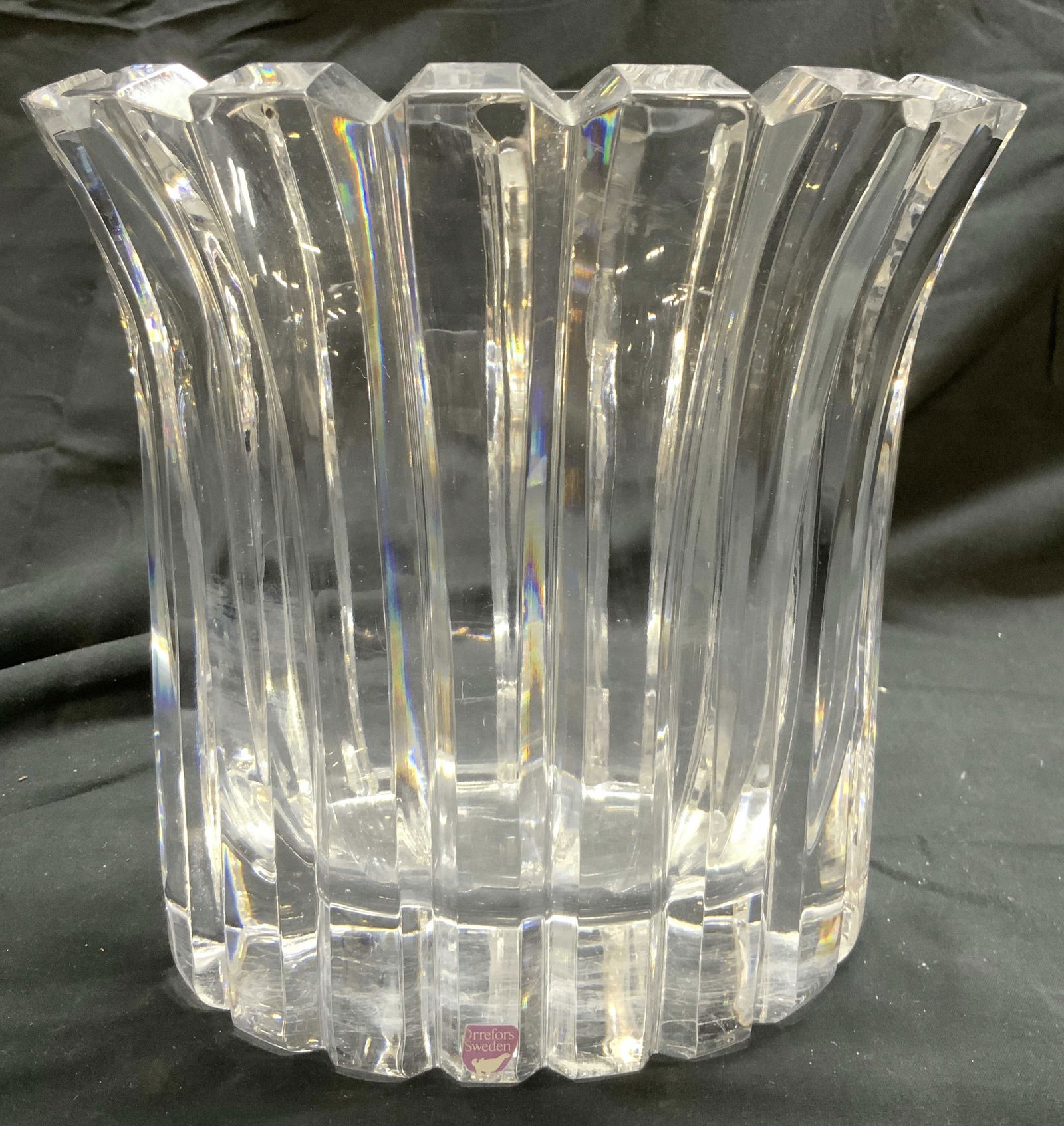 ORREFORS SWEDEN Thick Walled Crystal Vase: Tag reads ORREFORS SWEDEN. Vase has thick walls. Piece appears to be crystal. Vase has toothed rim. Exterior is scalloped. Vase is significantly weighted. Piece measures approximately 7.5 inches tall