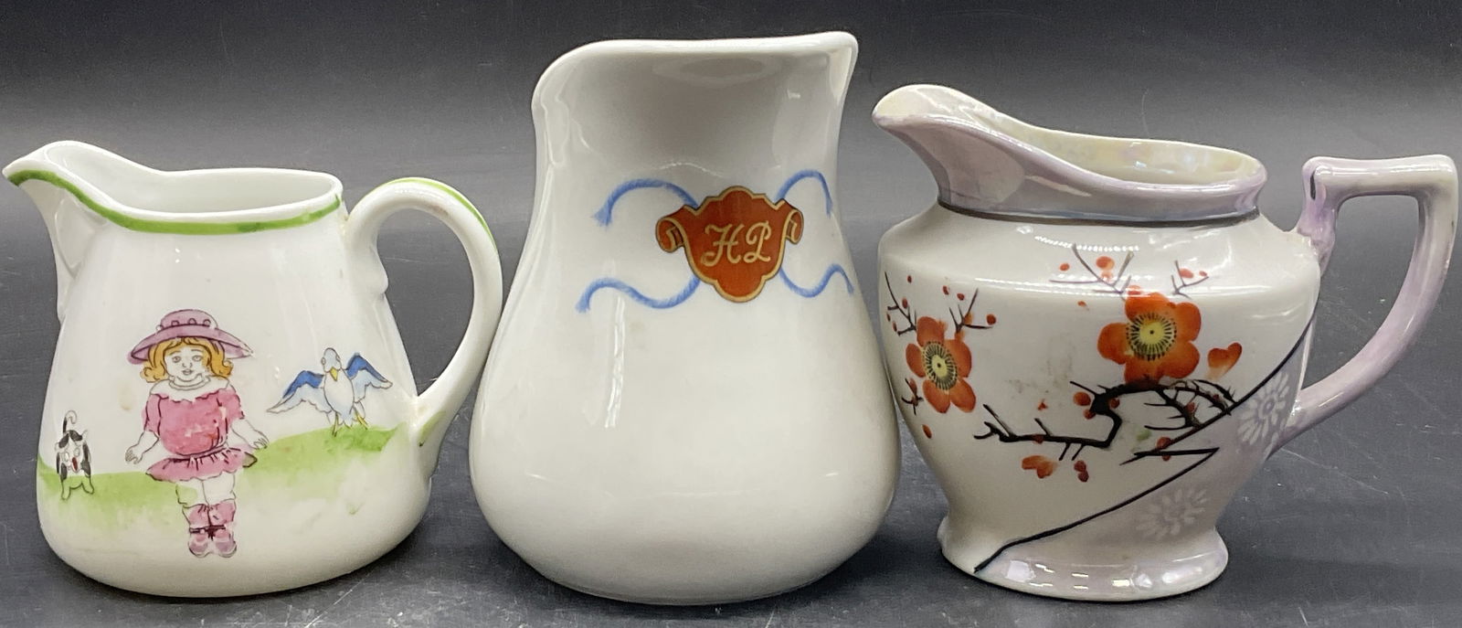 3 Vintage Porcelain Creamers, HAVILAND LIMOGES +: Three vintage porcelain creamers. Some pieces feature hand painted details. Undersides are marked: HAVILAND LIMOGES, HAND PAINTED NIPPON, and HAND PAINTED JAPAN. Designs include florals, a HL crest, a