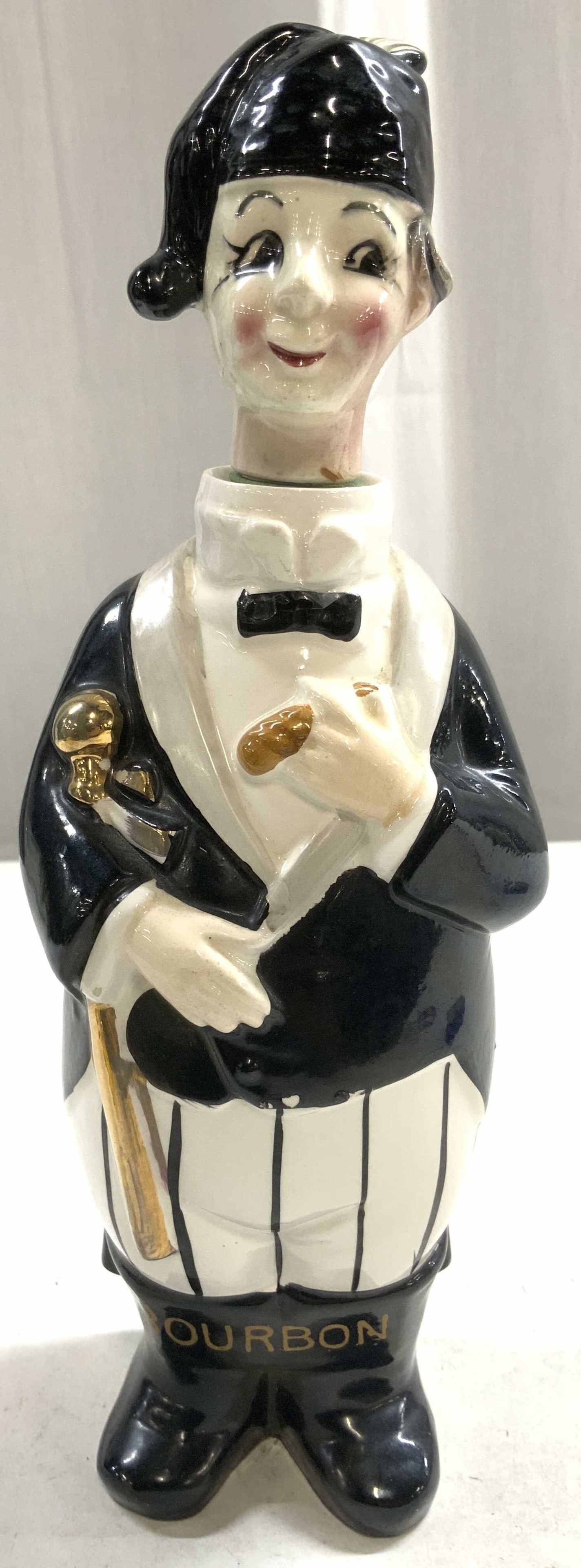 Vtg Swank Porc Member Of The Bar Decanter 5329: Underside is marked with crossed arrow trademark & 5329. Sticker on underside reads JAPAN. Decanter is vintage and porcelain. Piece depicts a male Swank Member Of The Bar figure with black & white det