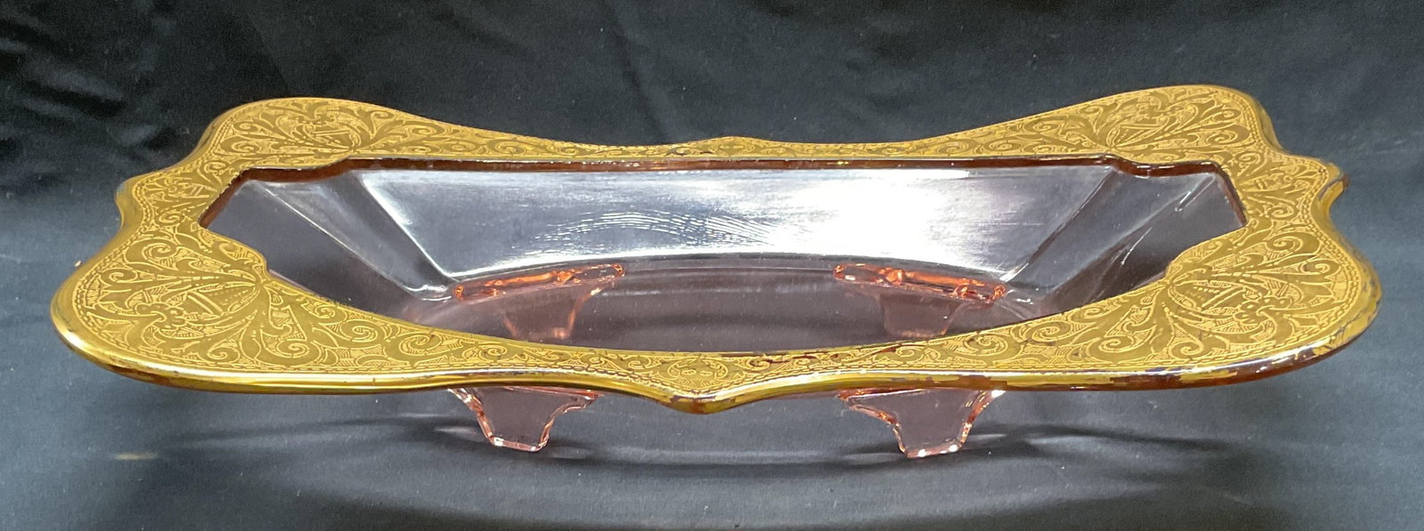 Vintage Pink Gilt Glass Bowl: Vintage pink depression glass bowl with gilt rim. Scroll design on rim. Measures approx. 14 x 7.75 x 3 inches. Loss to gilt and scratching observed. Depression glass bowl, pink glass bowl, gilt glass 