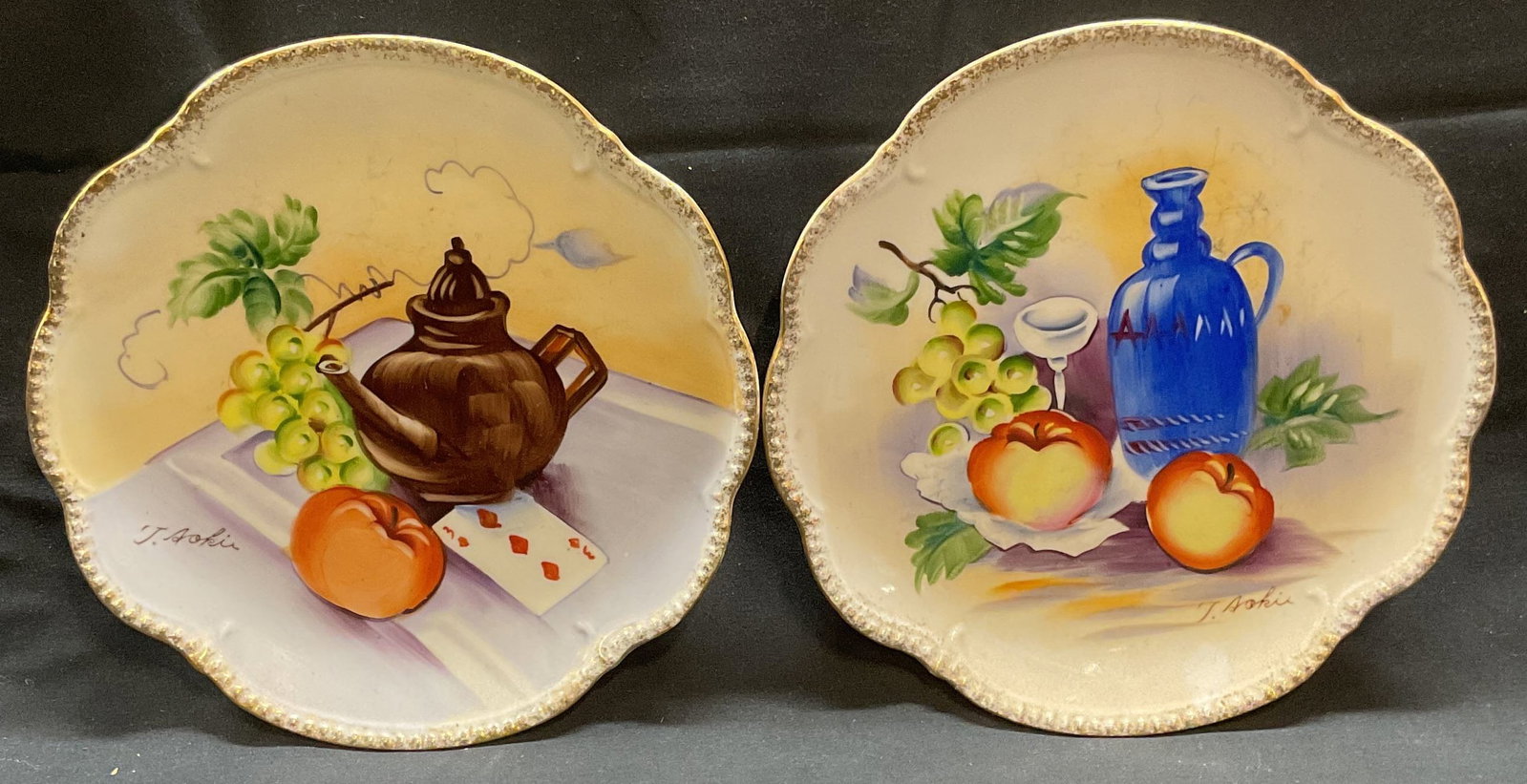 Pair Hand Painted Porcelain Still Life Plates: Pair of vintage hand painted porcelain plates with still life motifs. Signed on plates. Measure approx. 8 inches wide each. Wear including scratching and loss to paint observed. Still life plates, han
