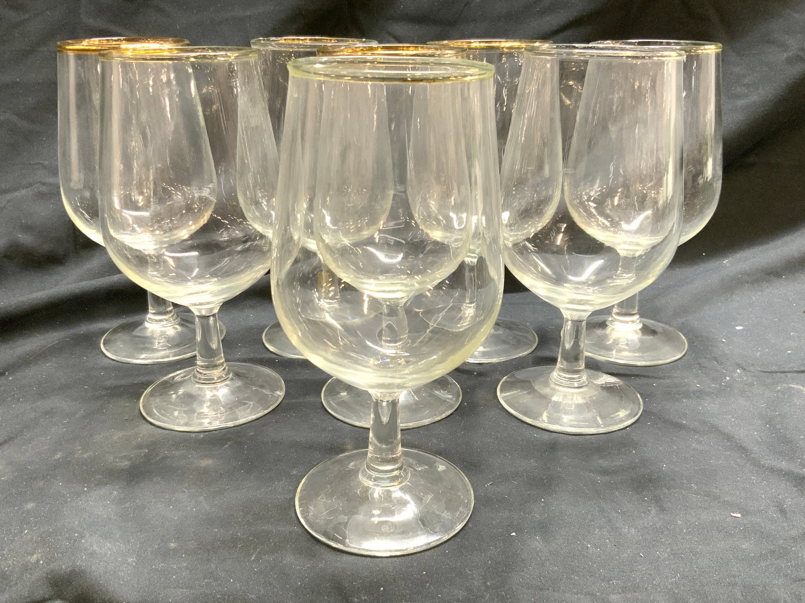 Set 8 Stemmed Water Goblets W Gilt Rims: Lot includes 8 Water goblets. Each have stems with circular bases. Goblets each have gilt rims. Vessels each measure approximately 7 inches tall 3.5 inches wide. Goblets, glass goblets, water goblets,