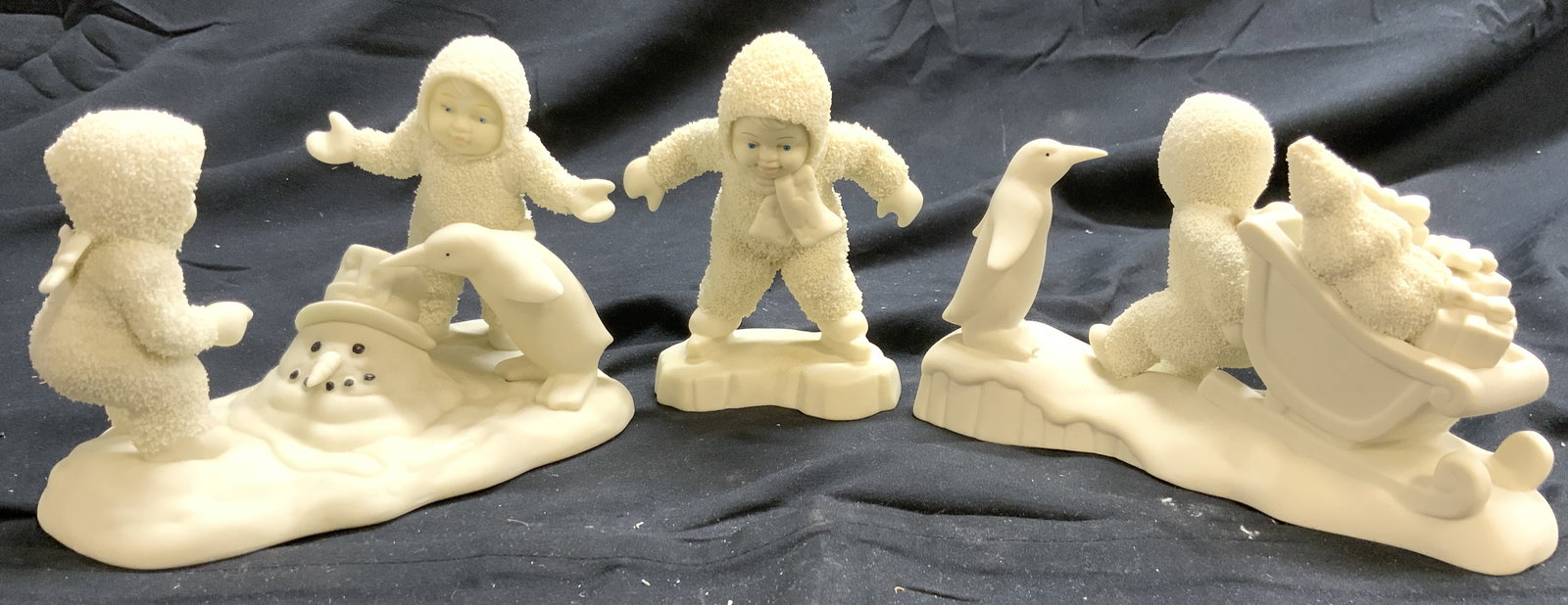 DEPARTMENT 56 Lot 3 Asst Porc Figures: Lot includes 3 porcelain figures. Including SKATE WITH ME, STUCK IN THE SNOW, & WHERE DID HE GO?. Each piece is cream toned and porcelain. Pieces each are part of Snowbabies series. Largest piece meas