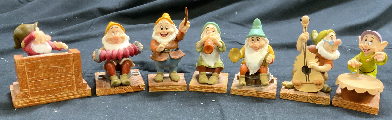 Lot 7 DISNEY SNOW WHITE Dwarfs Figurals: Undersides of each piece are marked WALT DISNEYS SNOW WHITE & THE SEVEN DWARFS, ENESCO GROUP INC. Lot includes DOC, GRUMPY, BASHFUL, SLEEPY, DOPEY, SNEEZY, & HAPPY. Each piece appears to be crafted fr