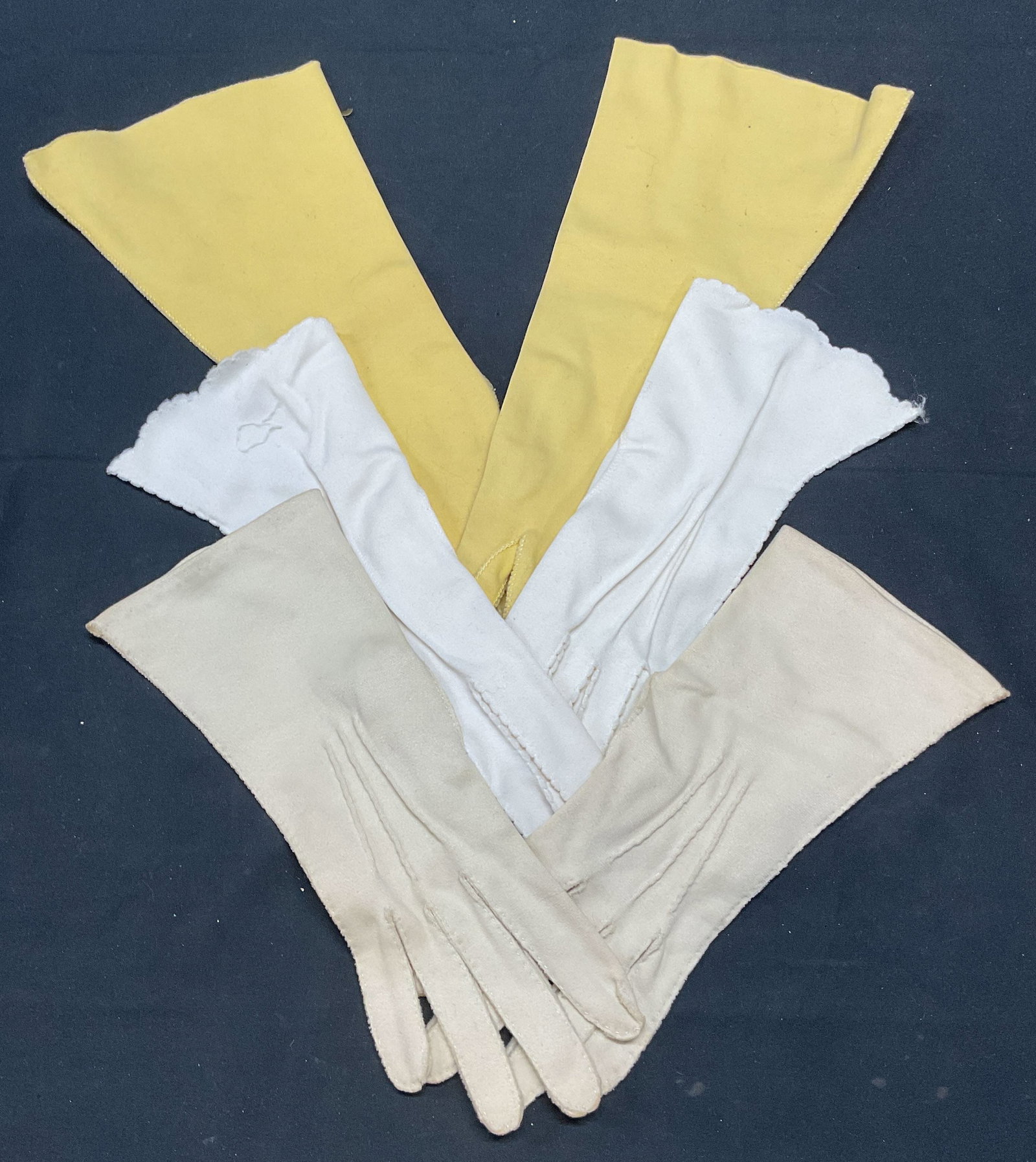 Lot 3 Vtg Cotton Gloves, Kayser, Lee Begman: Lot of 3 pairs of vintage cotton gloves in white and yellow. Signed Kayser, Lee Begman, and Crescendoe. Longest measure approx. 13 inches. All pieces have some wear consistent with exposure. Gloves, v