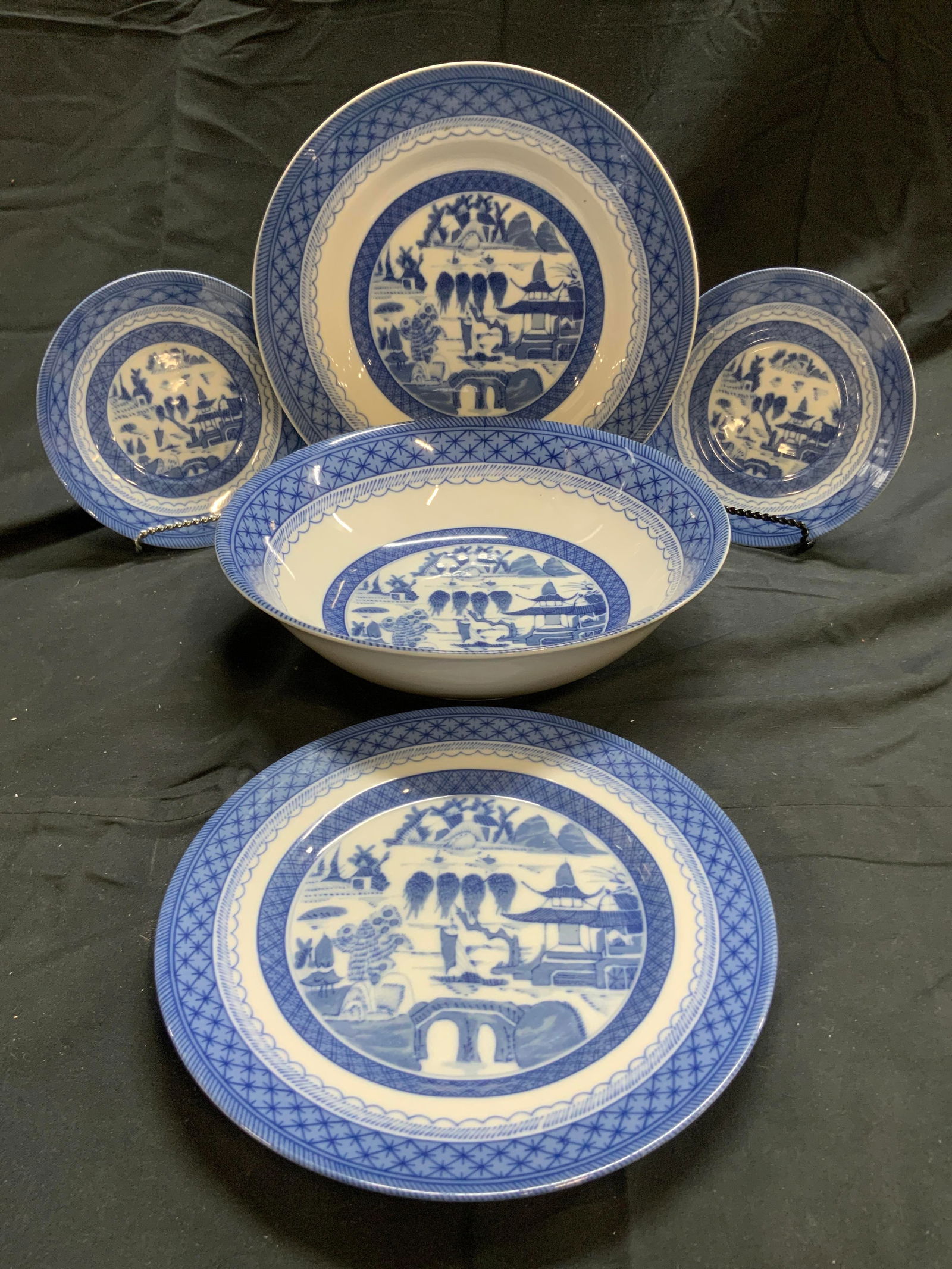 CHING TOSCANY COLLECTION Lot 5 Porcelainware: Undersides are marked CHING TOSCANY COLLECTION. Lot includes 2 bread plates, 1 bowl, 1 salad plate and 1 dinner plate. Each piece is white and blue toned with patterned detailed edges and landscape de
