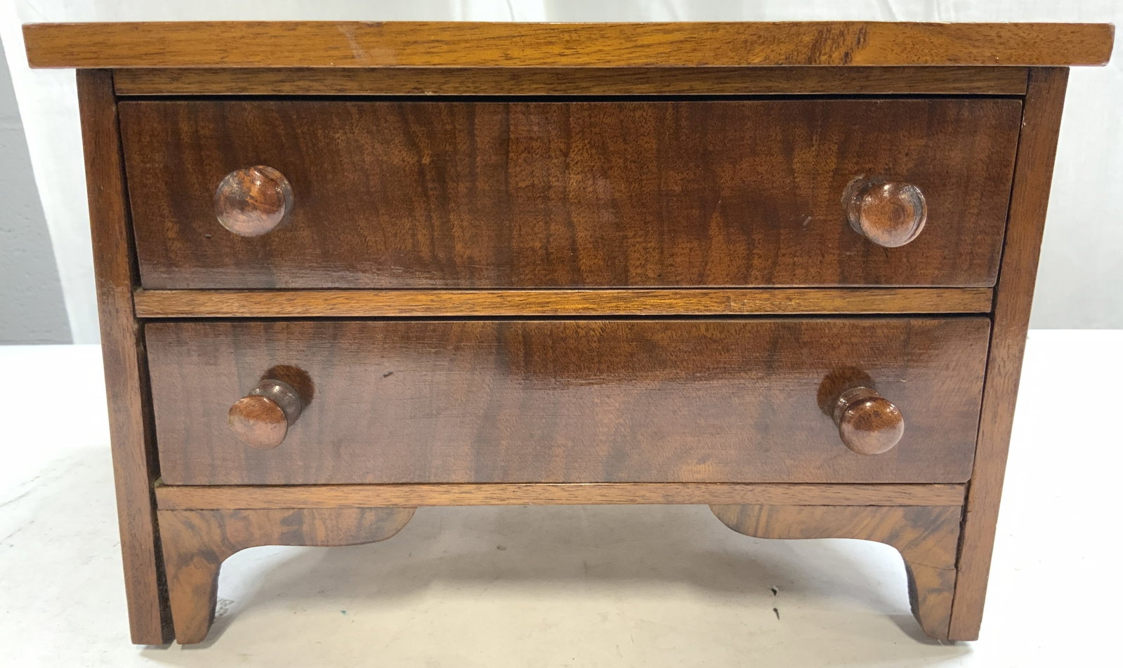 Vintage Wooden Dresser Form 2 Drawer Chest: Chest is tan toned and wooden. Piece has 2 drawers, each with 2 knob form handles. Chest has dresser form. Piece is vintage. Chest measures approximately 12 inches wide 8 inches tall & deep. Chest, wo