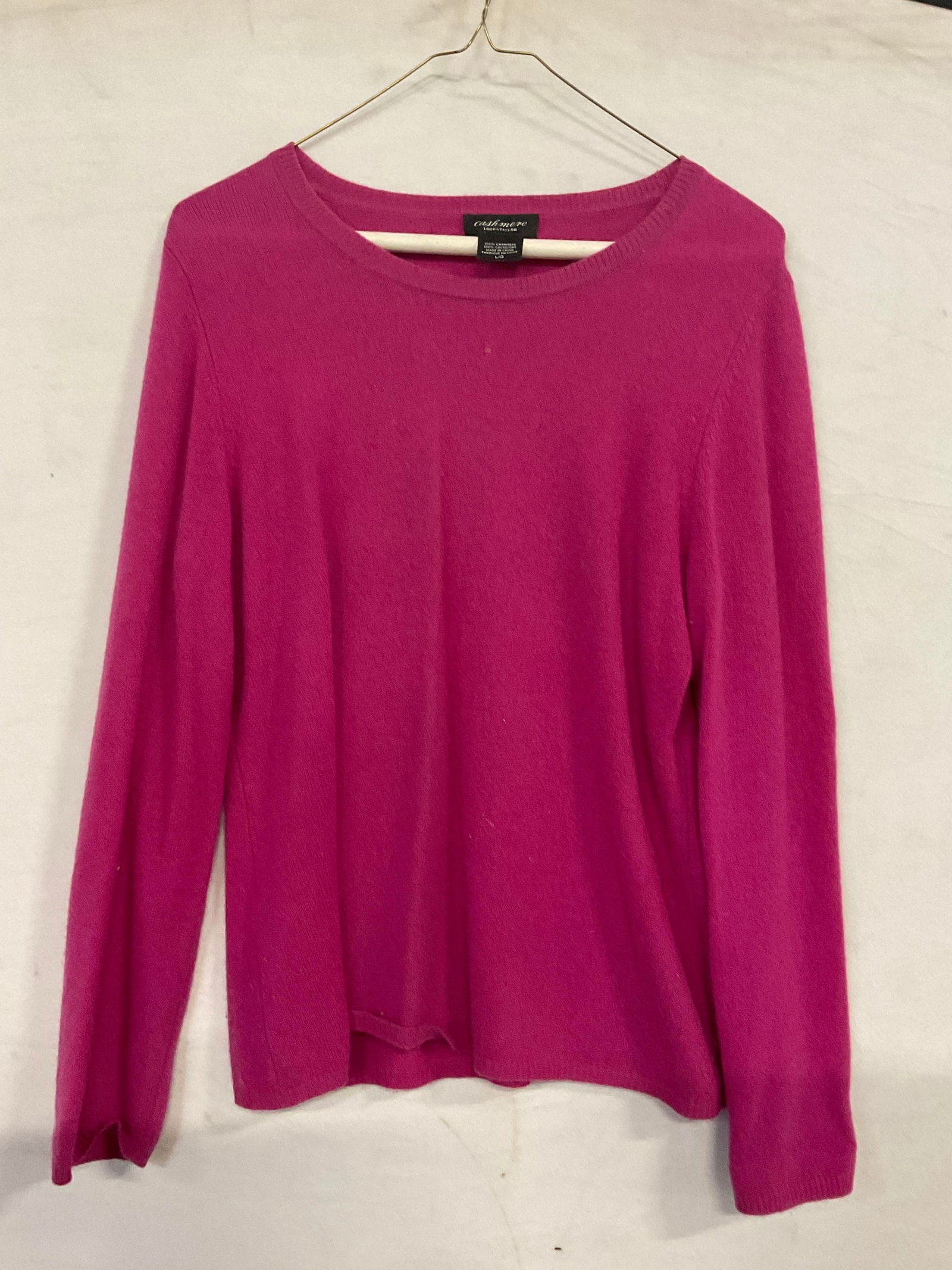 LORD & TAYLOR Vintage Pink Cashmere Sweater: LORD & TAYLOR Vintage Pink Cashmere Sweater. Long sleeved. Tags read LORD & TAYLOR, 100% CASHMERE, L. Surface wear, discoloration, and residue present. Wear to fabric. Punctures present. Measured flat