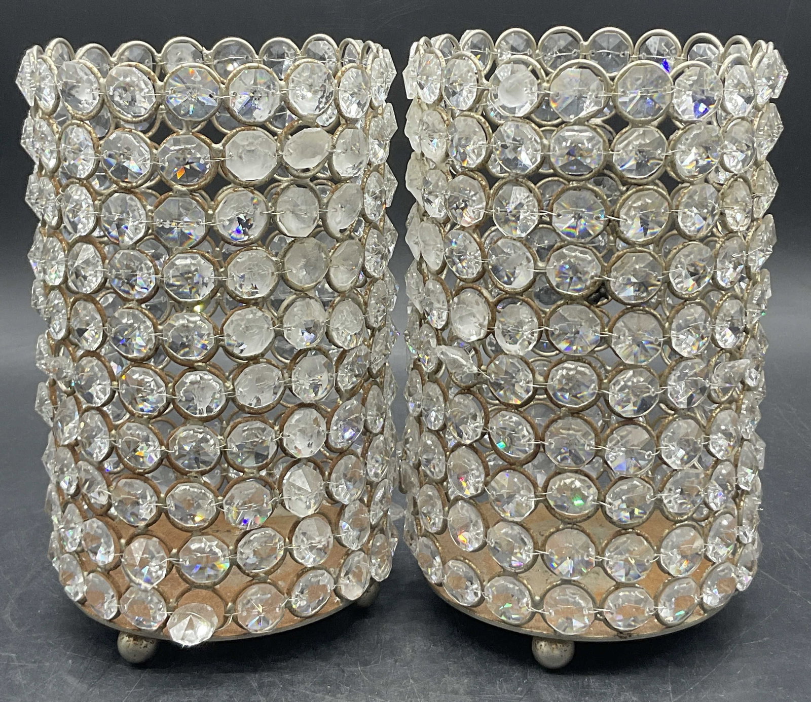 Pair INTERNATIONAL MERCANTILE Candle Holders: Pair of INTERNATIONAL MERCANTILE AGENCIES Candle Holders. Comprised of metal and faceted colorless crystals. Cylindrical form. Sticker to one underside reads INTERNATIONAL MERCANTILE AGENCIES and the 