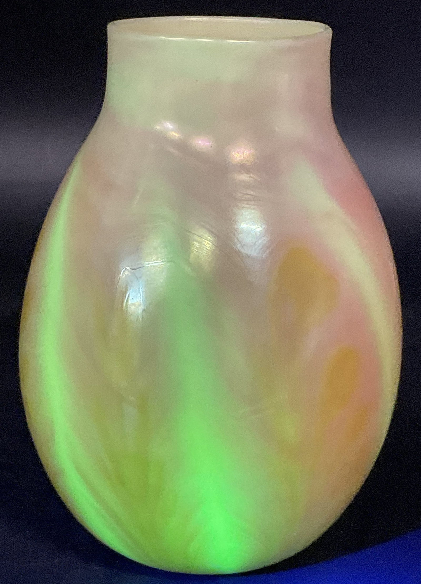 1974 LOTTON BURMESE Signed Art Glass Vase: 1974 LOTTON BURMESE Signed Art Glass Vase. Glows under blacklight. Underside signed LOTTON BURMESE FEB 11 1974. Measures approx. 7.25H x 4W in. Width measured at widest point. Pontil to underside. Sur