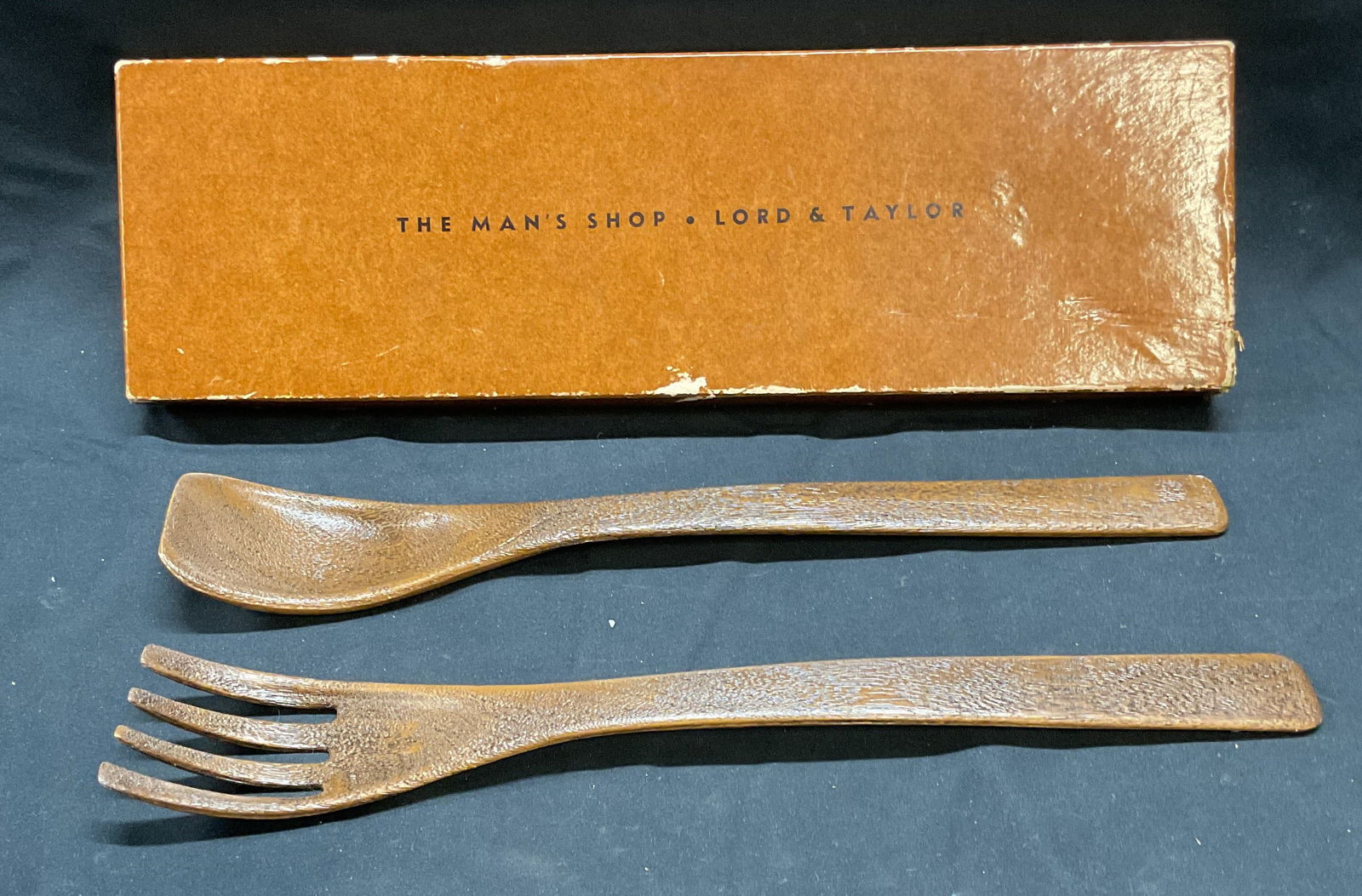 Set 2 Faux Wood Salad Serving Fork & Spoon: Set of faux wood salad serving utensils. Fork and spoon. Plastic. Measure approx. 12.25 inches each. Includes box. Both pieces have some wear consistent with exposure.