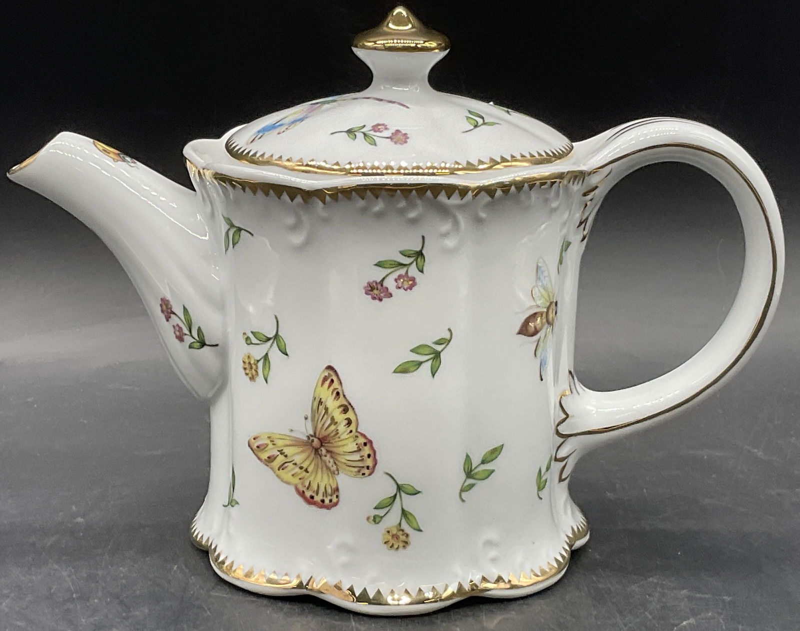 I. GODINGER & Co. Porcelain Dragonfly Teapot, Lid: I. GODINGER & Co. Porcelain Dragonfly Teapot. Lidded. Decorated with various insects which include dragonflies, ladybugs, butterflies, and more. Florals throughout the design as well. Gilt line work t