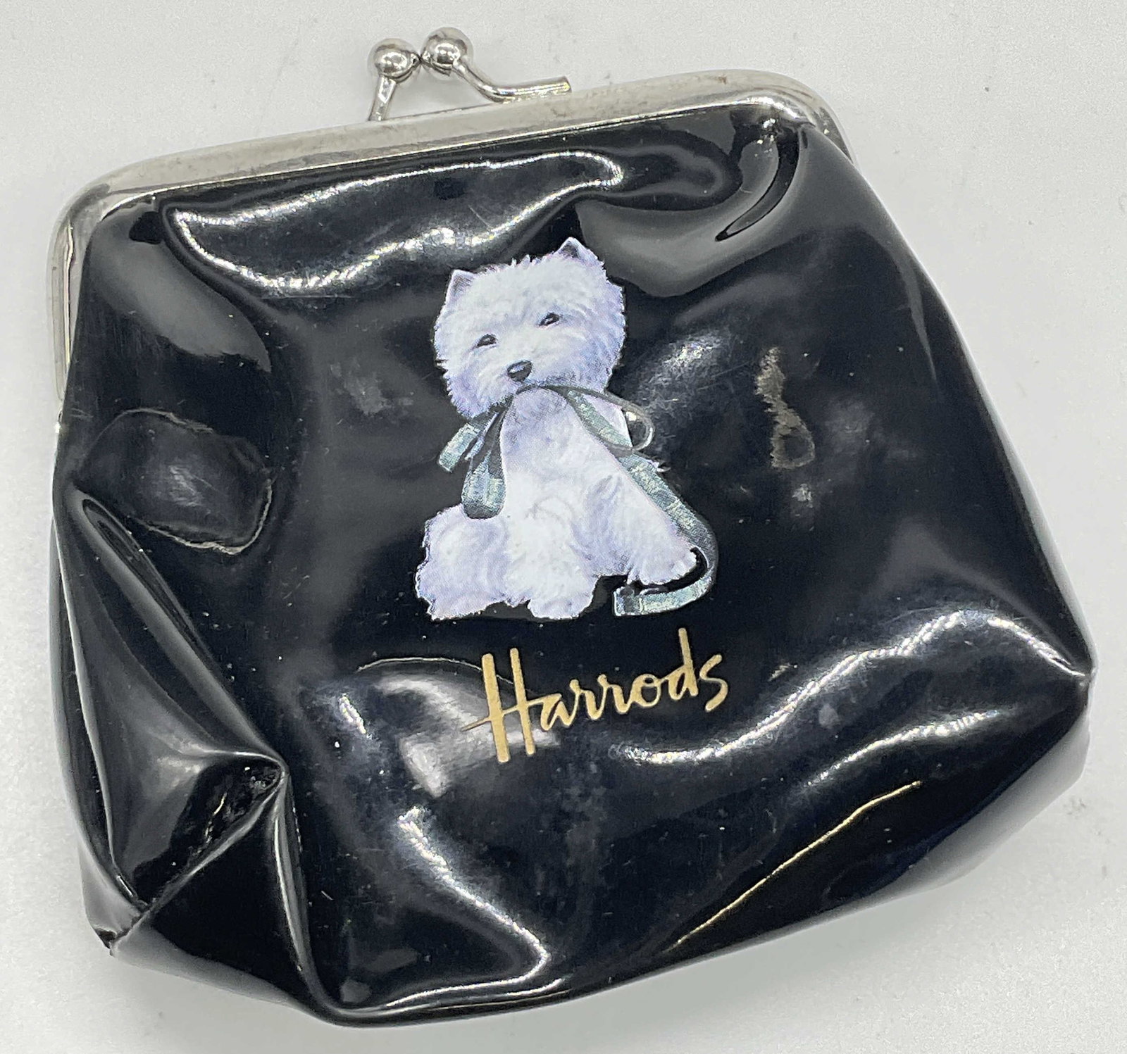 HARRODS White Westie Dog Motif Coin Purse: HARRODS White Westie Dog Motif Coin Purse. Measures approx. 4L x 4W in. Silver tone metal hardware closure. Material tag reads Polyester & PVC. Surface wear, warping, and discoloration present. home d