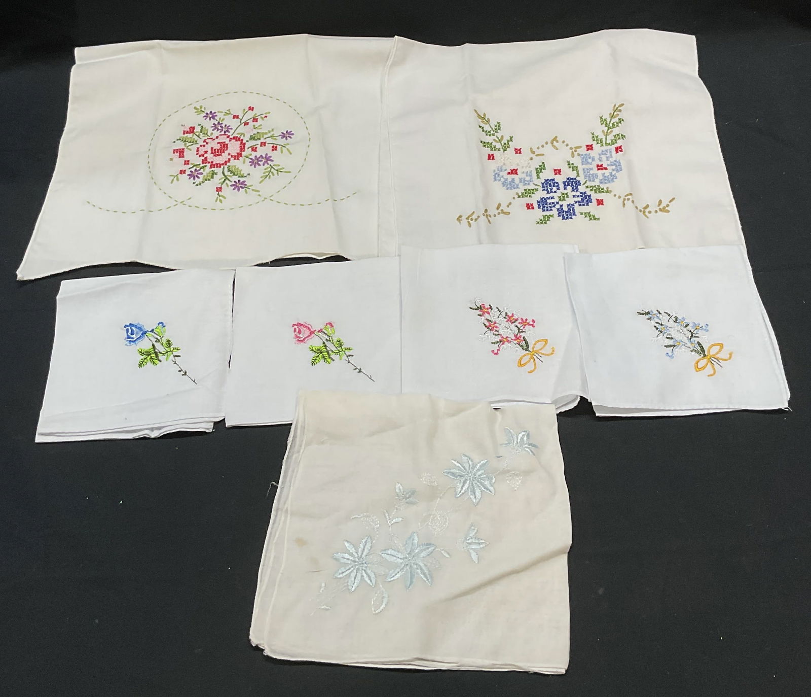Group Lot Floral Handkerchiefs & Linens: Group lot of white cotton floral design handkerchief and linens. Cross stretch and embroidered decoration. Largest piece measures approx 20 x 11.5 inches. All pieces have some wear including blemishes