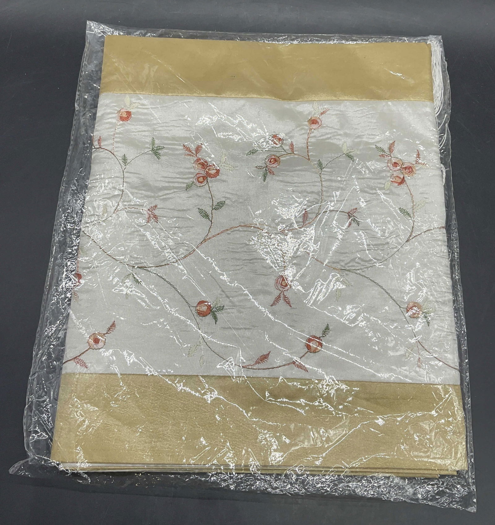 NIP Floral Motif Embroidered Scarf, Original Pckg: New in package Floral Motif Embroidered Fabric Scarf. Pink, green, white, and beige hues throughout. Contained in original clear packaging. Measures approx. 11.5W x 13.5L in. Not examined out of packa