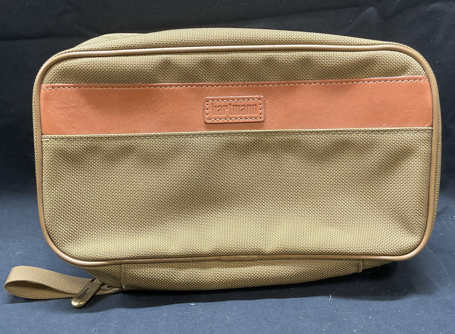 Hartmann Toiletry Bag, Travel Bag: Hartmann toiletry bag/travel bag. Brown canvas with leather trim. Signed on exterior. Measures approx 10.5 x 3 x 5.75 inches. Some wear including blemishes observed. Hartmann, Hartmann bag, travel bag