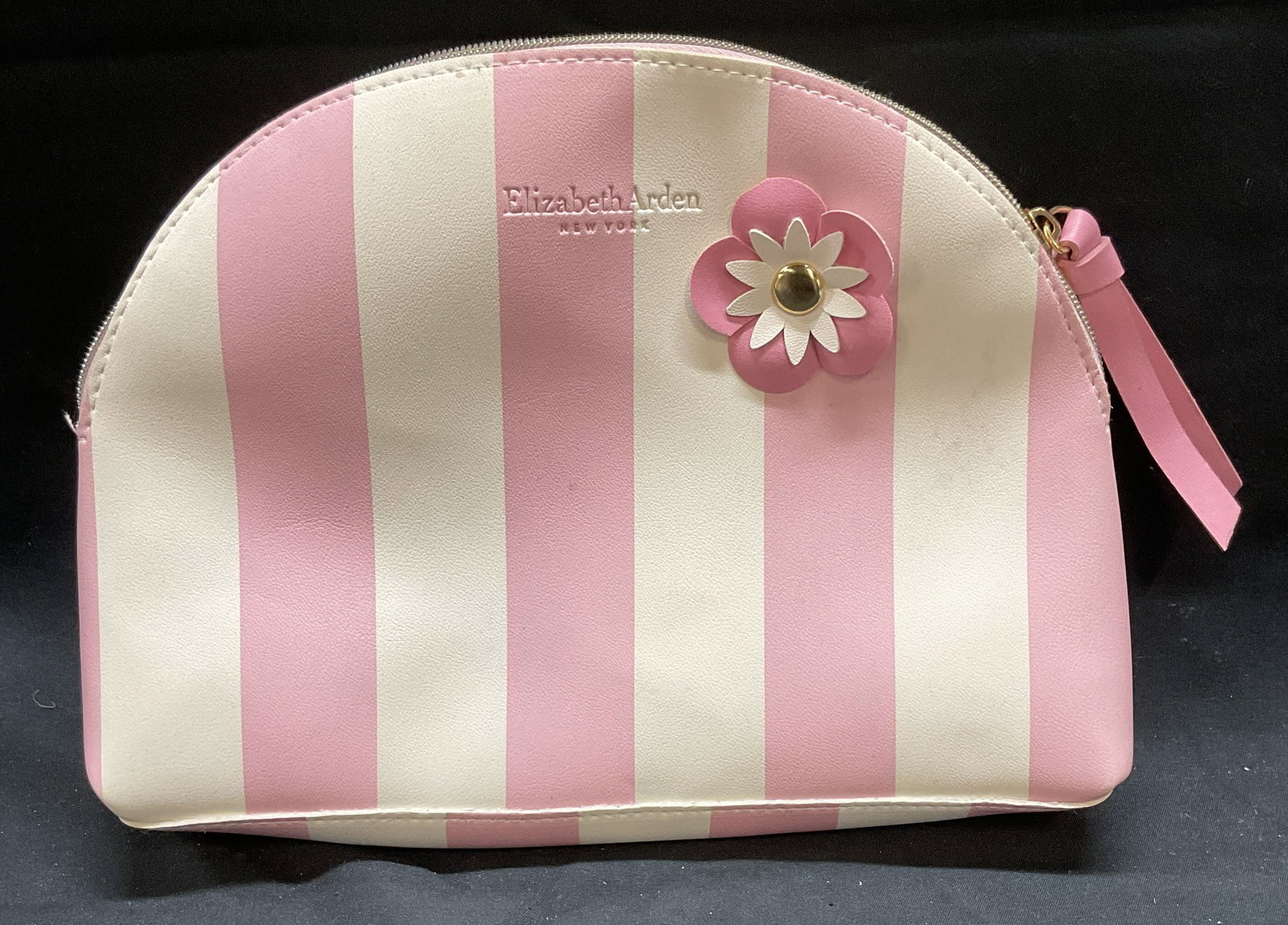 Elizabeth Arden Pink & White Cosmetic Bag: Elizabeth Arden pink and white striped floral cosmetic bag. PVC. Measures approx. 9 x 2 x 7 inches. Some blemishes observed. Elizabeth Arden, Elizabeth Arden cosmetic bag, pink cosmetic bag, white cos