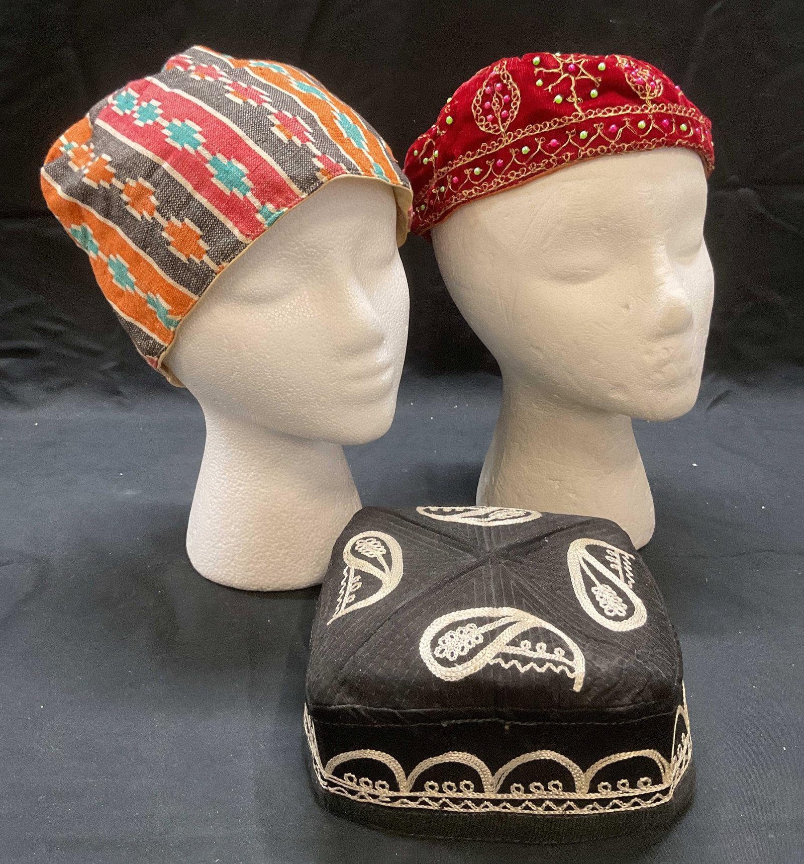 Lot of 3 Vintage Russian Hats: Lot of 3 vintage Russian style hats. Red velvet with gold tone embroidery and beading. Black with white paisley pattern embroidery. Multicolor knit with geometric pattern. Largest measures approx. 7.5