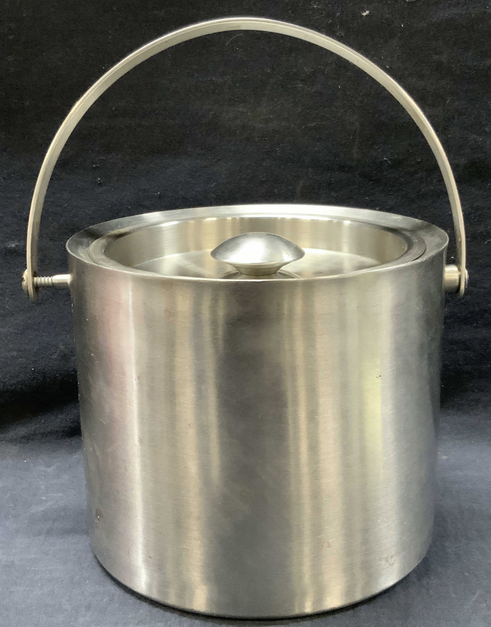 Vintage Metal Ice Bucket: Vintage metal made ice bucket with top handle. Approx 6.25 inches tall and 7.5 inch diameter. Evident blemishes and residue throughout metal. Vintage metal ice bucket, ice bucket, vintage bar ware, me