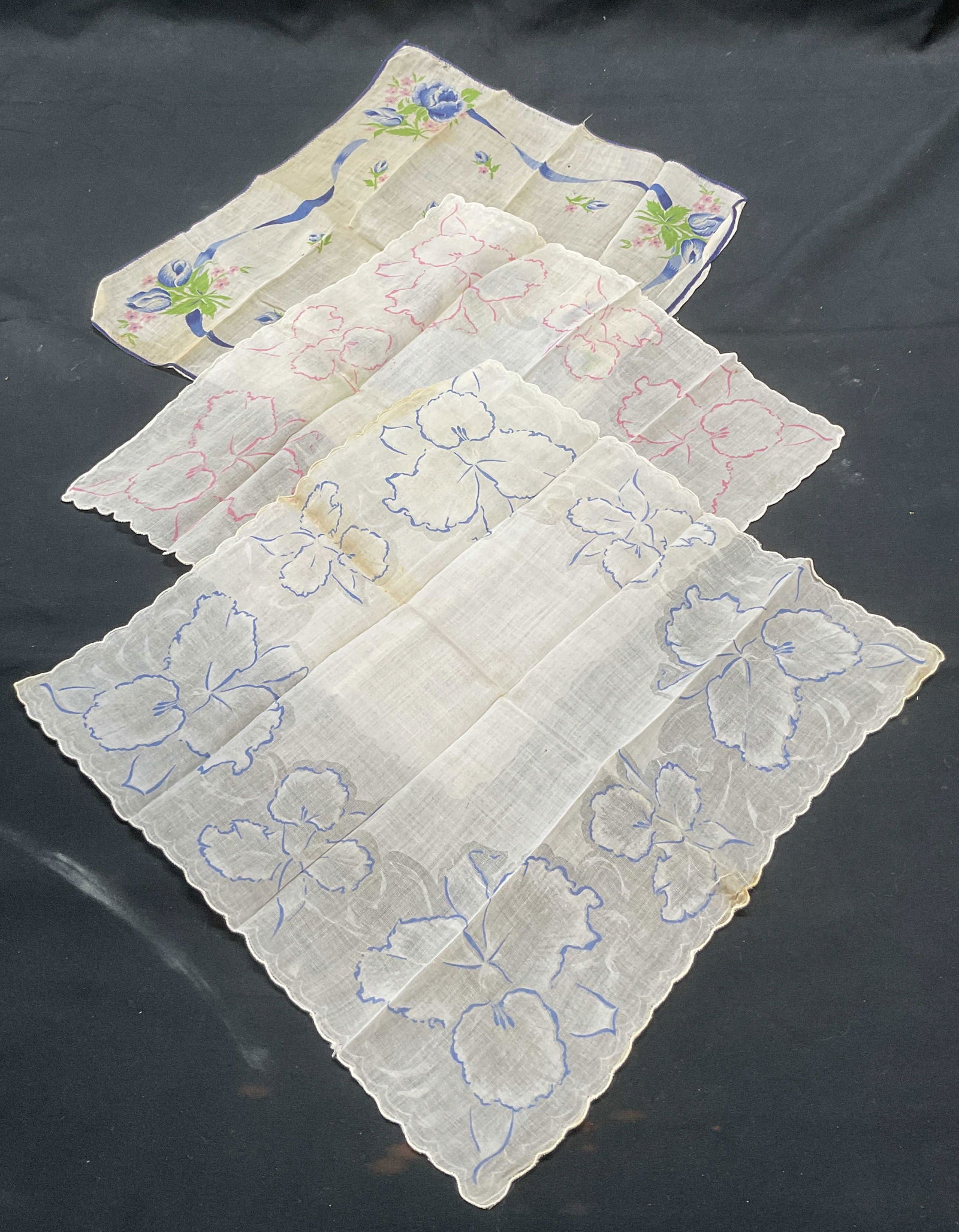Lot 3 Vintage Floral Handkerchiefs: Lot of 3 vintage floral print handkerchiefs. Pink and blue on white. Materials feels like cotton. Largest measures approx. 11 x 10 inches. All pieces have wear including blemishes and tearing observed