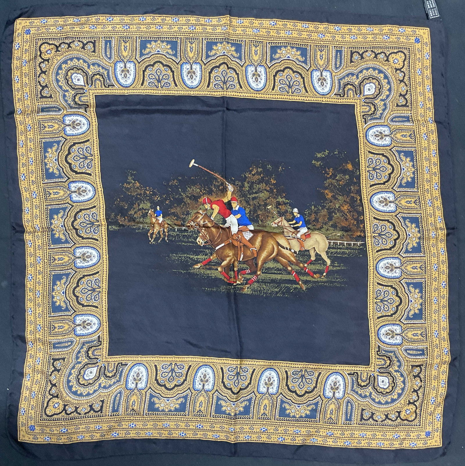 Black Silk Horse Polo Player Scarf, Italy: Black silk scarf with decorative border and polo players on horseback motif. Hand rolled edges. Made in Italy. Measures approx. 16.5 x 17 inches. Some wear to material consistent with exposure. Scarf,