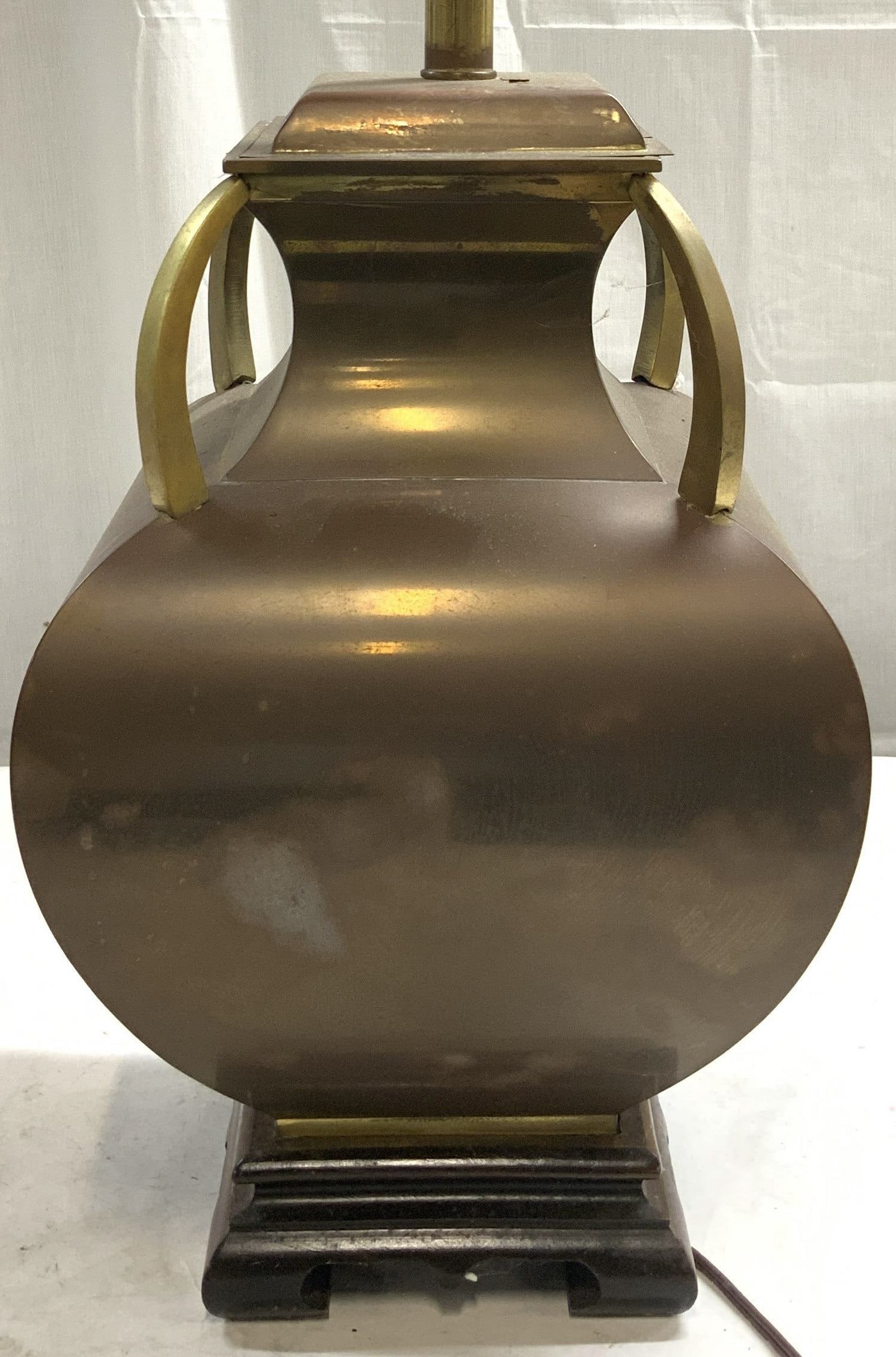 Vintage Copper & Gilt Metal Lamp: Lot is copper and gilt metal. Piece has harp and silver toned finial. Piece has brown toned carved wooden base. Lamp has twist switch on bulb socket. Lamp measures approximately 32 inches tall 10.5 in