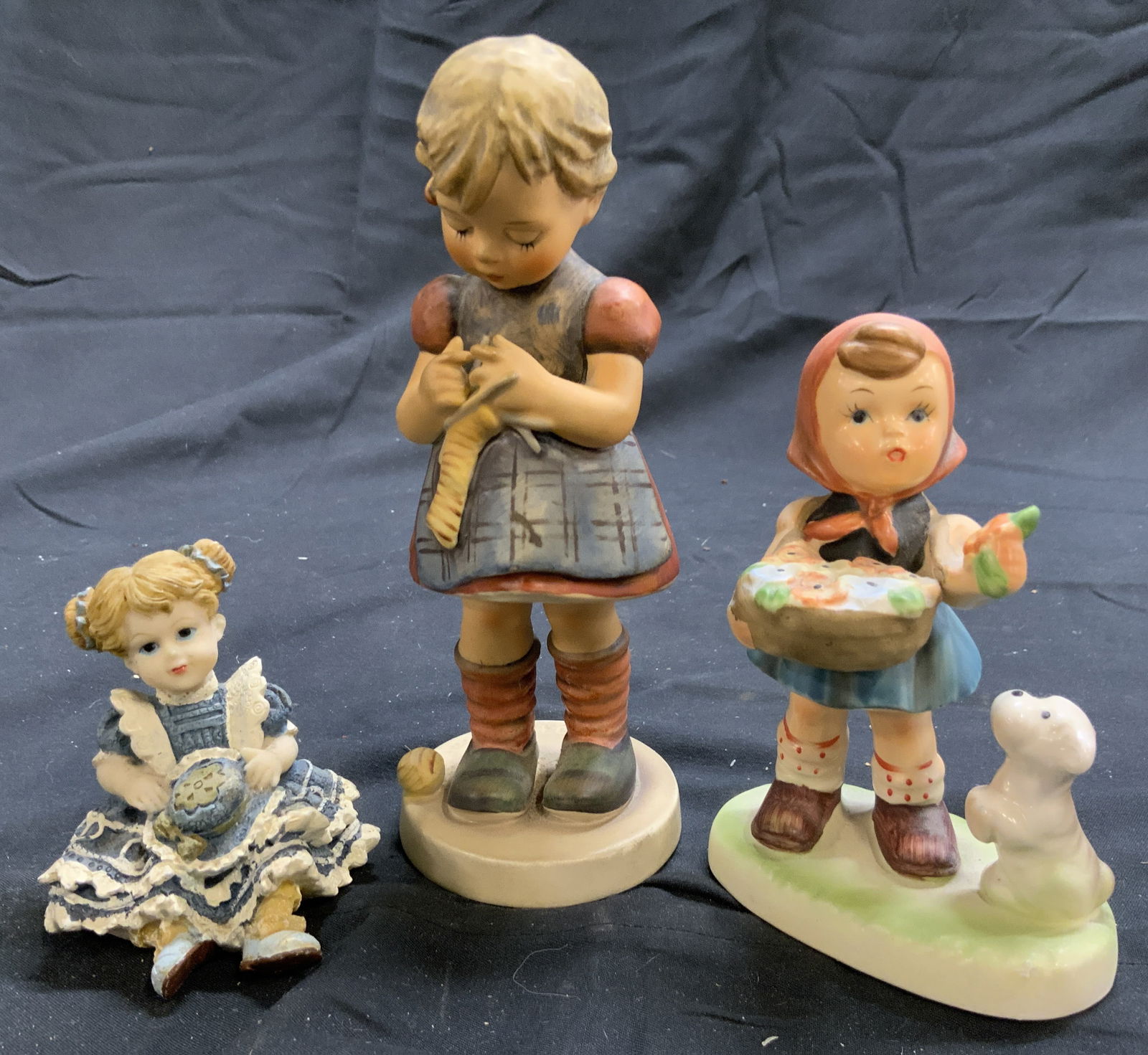 Lot 3 Asst Porc & Resin Female Child Figures: Lot includes 1 figure marked MJ HUMMEL GOEBEL W GERMANY, 1 with tag which reads. NAPCOWARE, & 1 with tag which reads PRESTICE. Two pieces are porcelain, 1 is resin. Largest figure measures approximate