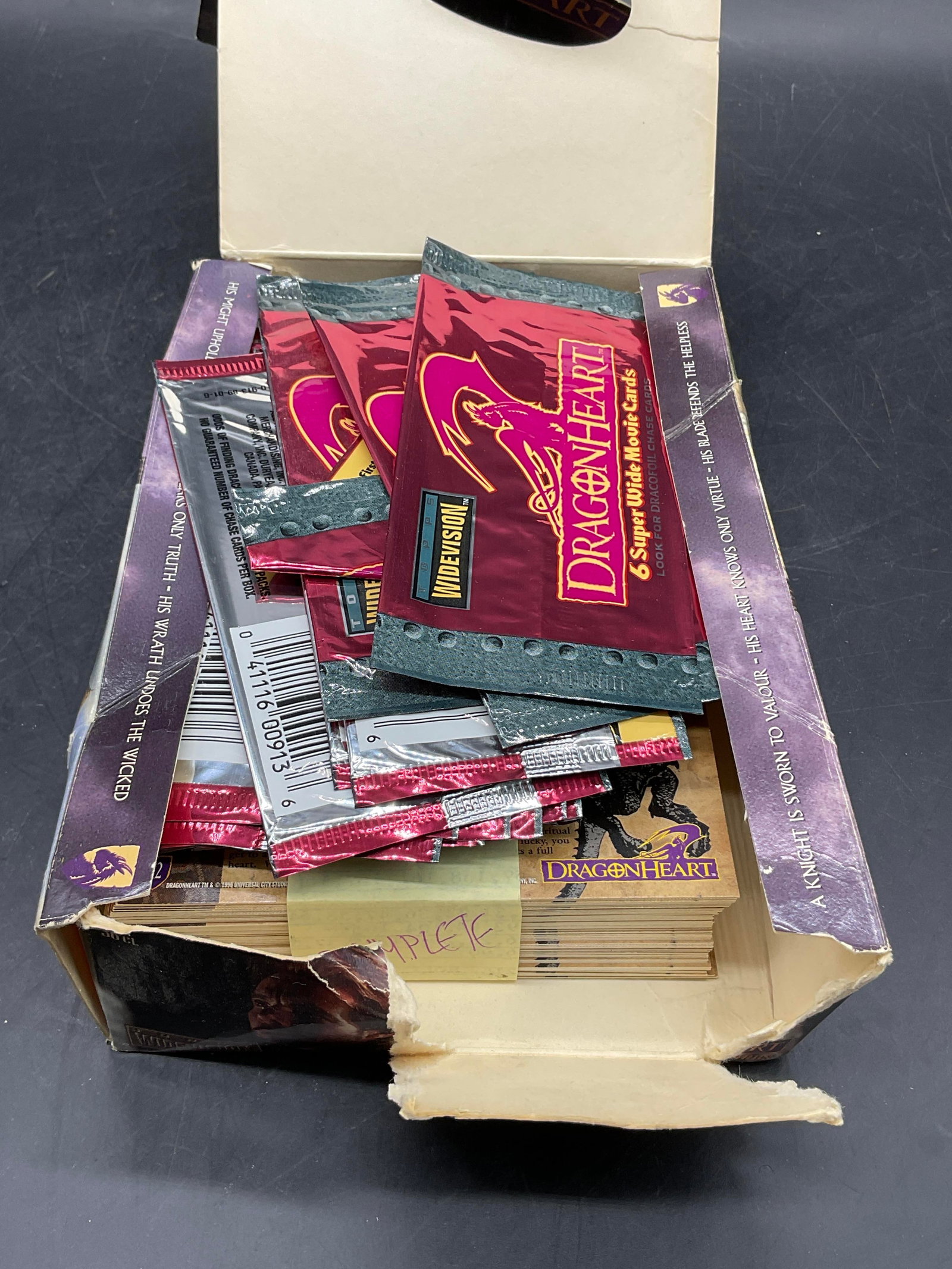 TOPPS DRAGONHEART Trading Cards, Bx 1996: TOPPS DRAGONHEART Collectible Trading Cards. Comes with box and some card packaging. Unexamined lot. Box measures approx. 2H x 8.25L x 5.5W in. C. 1996 UNIVERSAL CITY STUDIOS, INC. Losses to the box. 