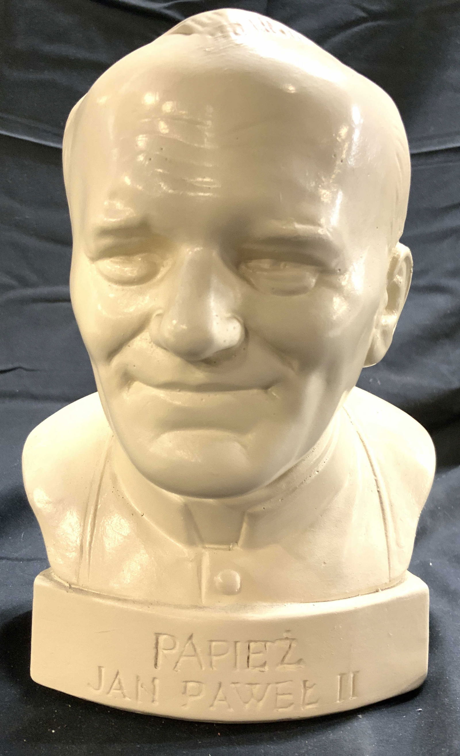 PAPIEZ JAN PAWEL II Plaster Bust: Bust reads PAPIEZ JAN PAWEL II. Bust is cream toned. Piece appears to plaster possibly composite. Bust has facial, hair, and yarmulke relief detail. Piece measures approximately 8.5 inches tall 6 inch