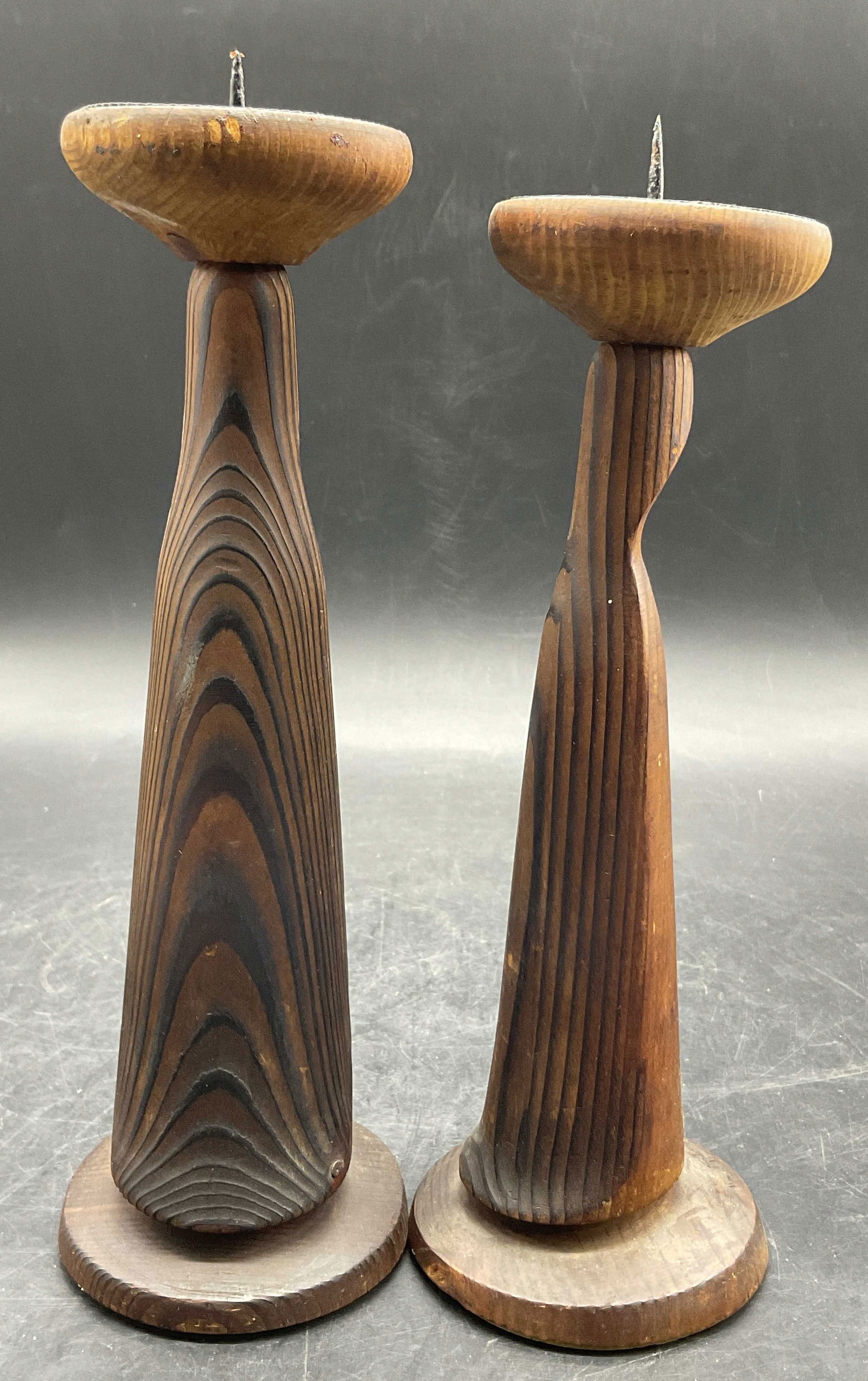 Pair MILENIUM Vintage Carved Wood Candlesticks: Pair MILENIUM Vintage Carved Wood Candlesticks. Tag to underside of one piece is in a foreign language, top reads MILENIUM. Larger piece measures approx. 10H x 3W in. Variations to the shapes of the c