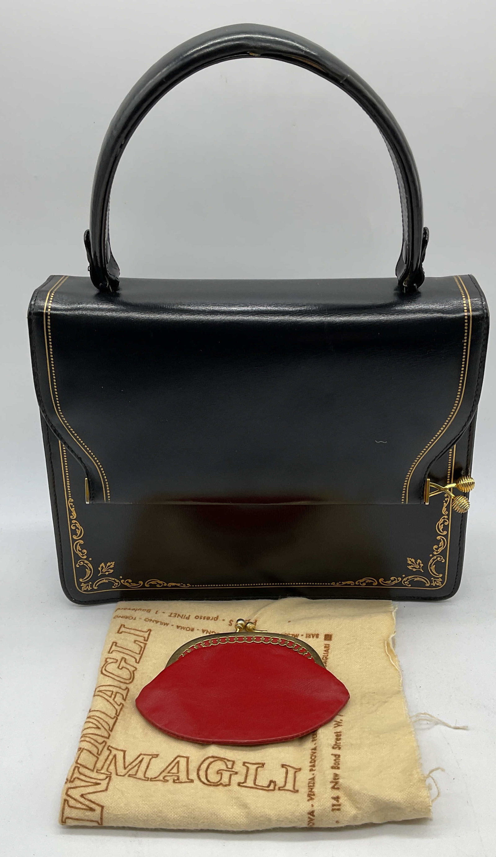 Vintage Black Gilt Leather Handbag +: Vintage black gilt leather handbag with red leather lining. Includes red leather coin purse and Magli dust cloth. Handbag monogrammed ECC under fold over flap. Interior handbag has multiple pockets. H