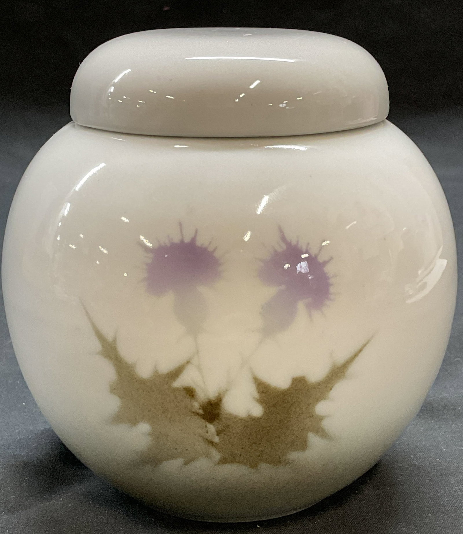 Highbank Porcelain Floral Ginger Jar, Scotland: Highbank porcelain ginger jar with lid floral motif. Made in Scotland. Signed on underside. Measures approx 4.5 x 4.75 inches. Some surface wear consistent with exposure. Highbank, Highbank ginger jar