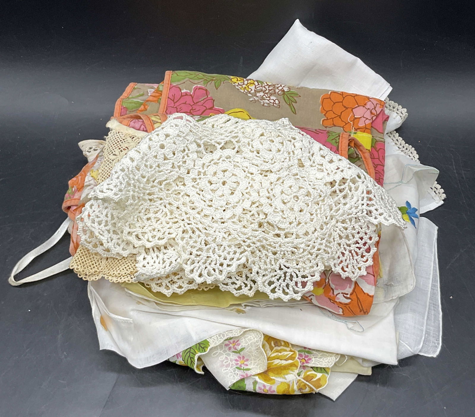 Grp Vntg Crochet Collars, Table Linens, & Fabrics: Group lot of vintage crochet collars, table linens, and textiles / fabrics. Yellow pure linen napkin measures approx. 10.25L x 10.25W in. Some pieces feature floral motifs, embroidery, or pierced fabr