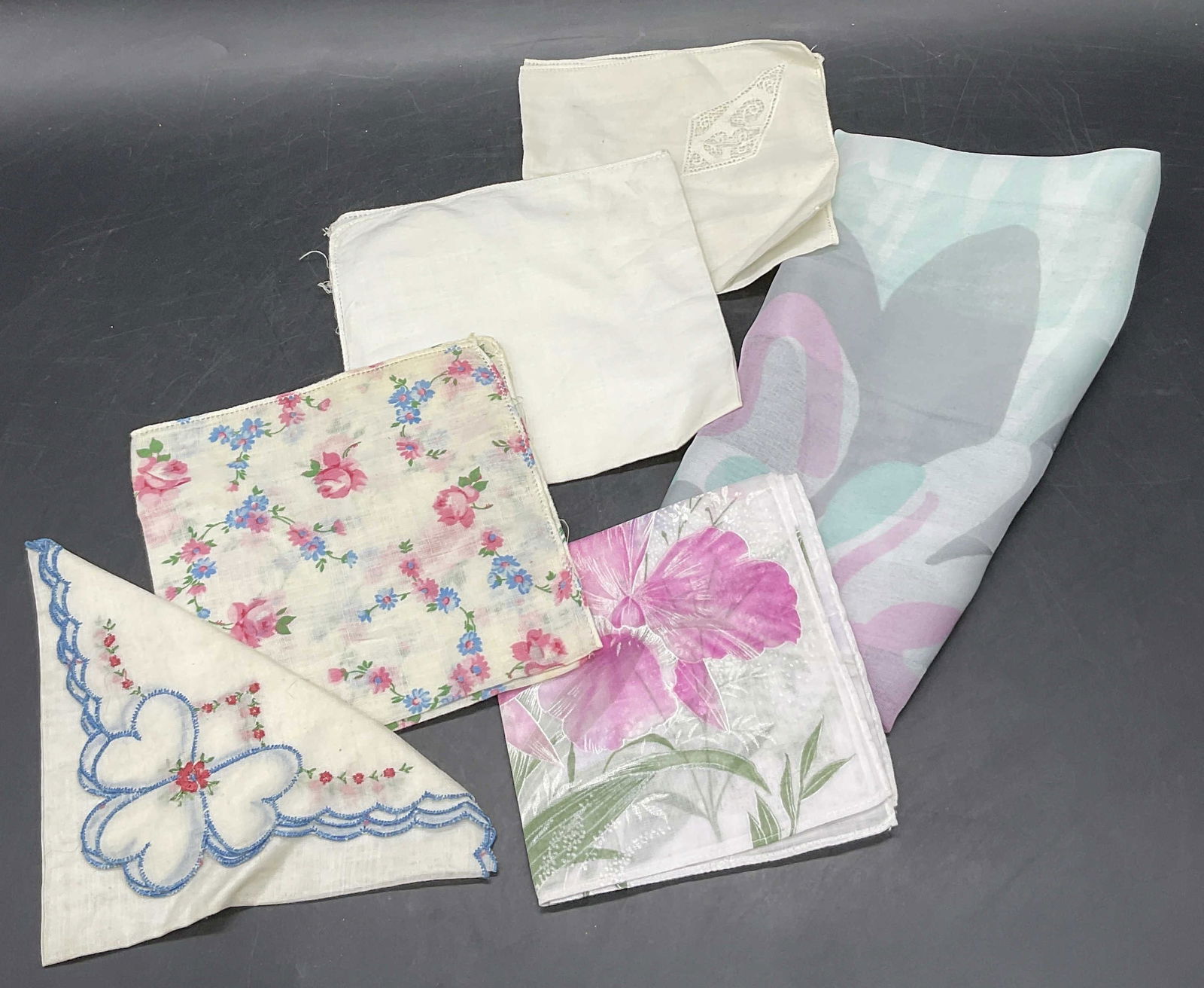 Lot 5 Vintage Handkerchiefs & Floral Italian Scarf: Lot of Four Vintage Handkerchiefs And One Vintage Scarf. Variety of colors and sizes. Floral motifs, solid white, and pierced fabric details. Scarf measures approx. 61L x 12W in. Tag to scarf reads 10