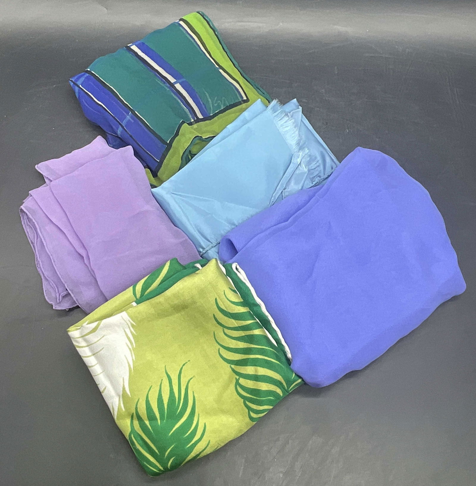 Grp Lot Multicolored Fabric Fashion Scarves, Vera+: A Group of Five Multicolored Fabric Fashion Scarves. Some scarves are solid colors. Various sizes. Crafted from a variety of soft hand fabrics. Some are branded VERA. GLENTEX silk feather motif scarf